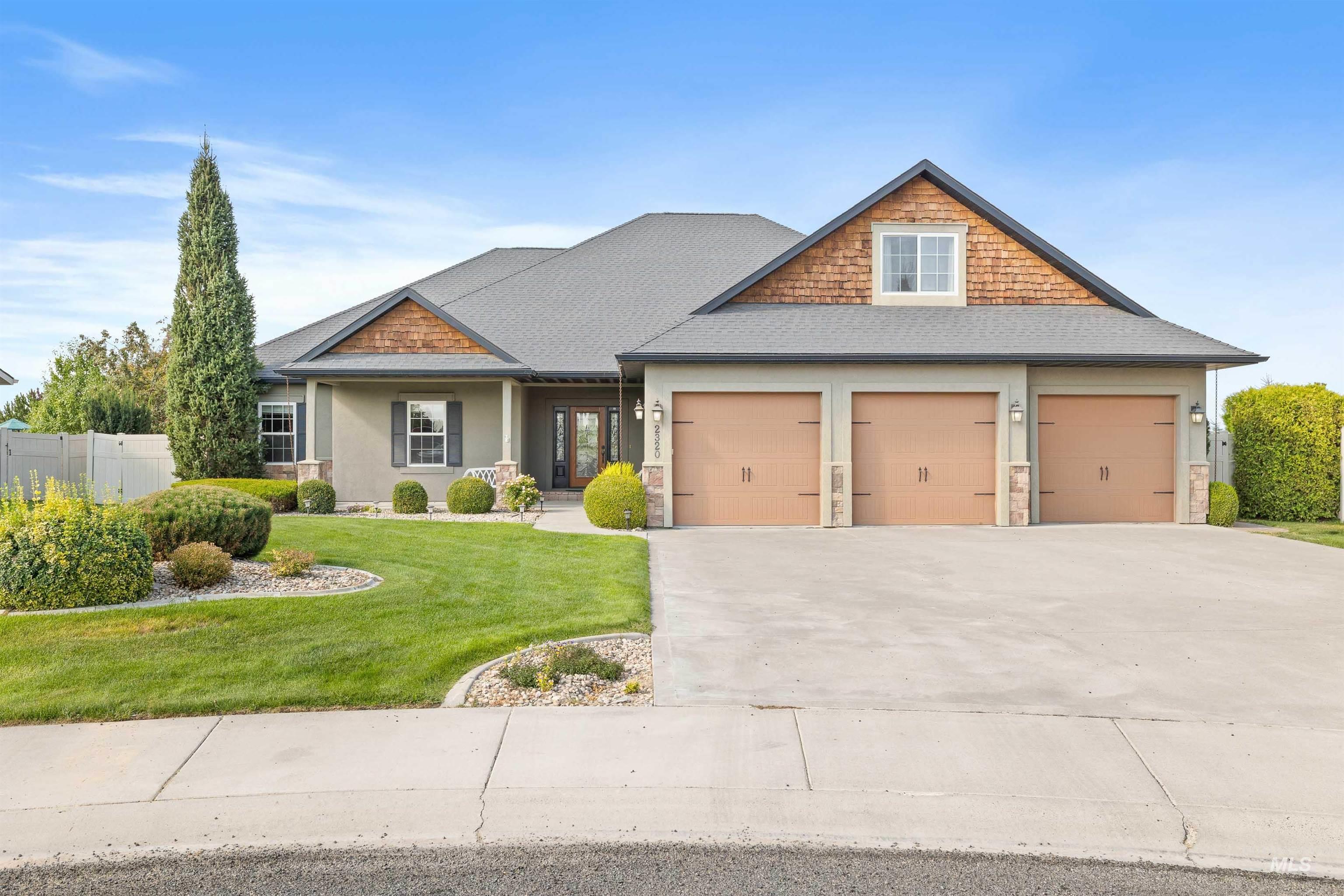 Craftsman inspired home featuring a shingled roof, concrete driveway, stone siding, a garage, and a porch