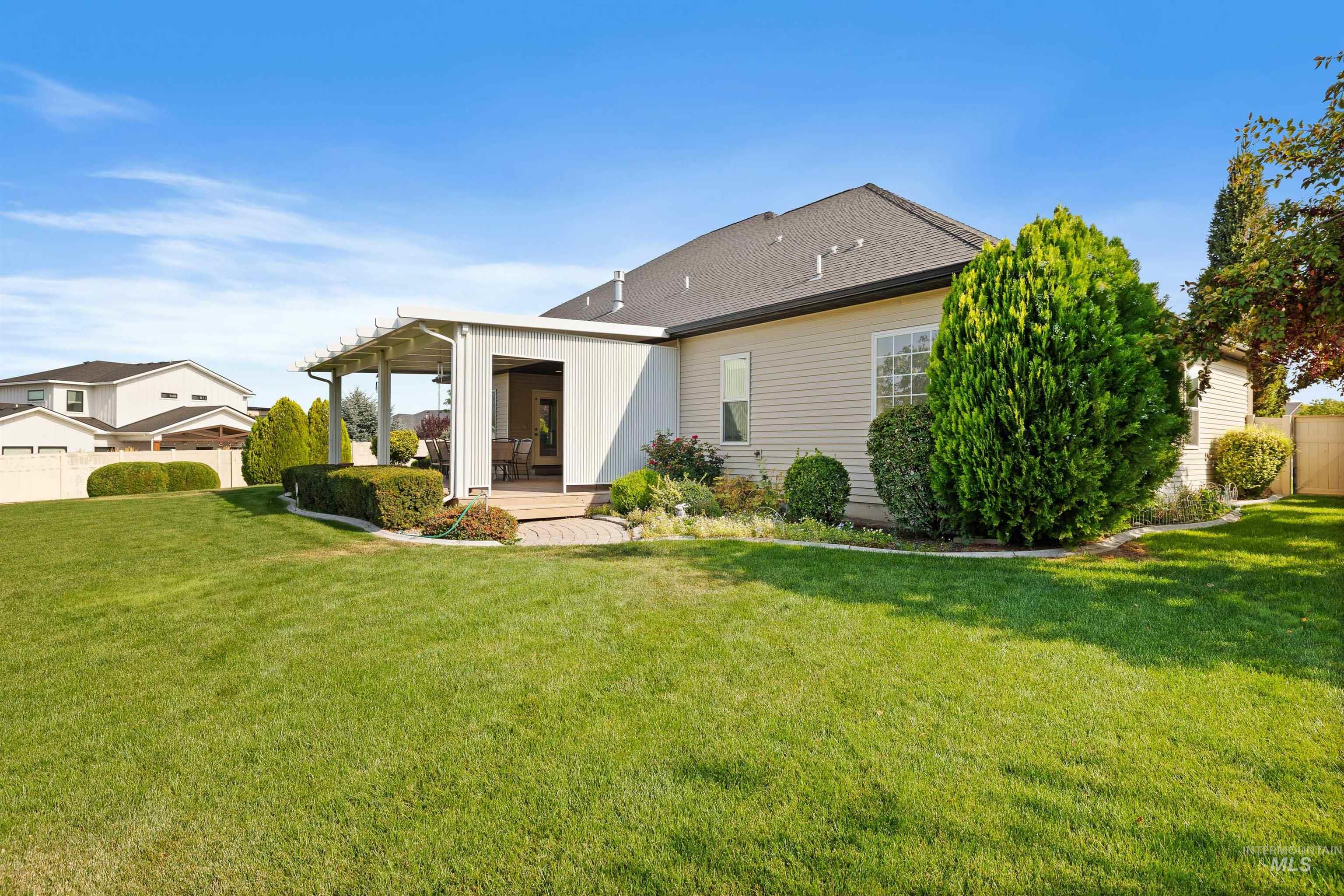 Rear view of property featuring roof with shingles