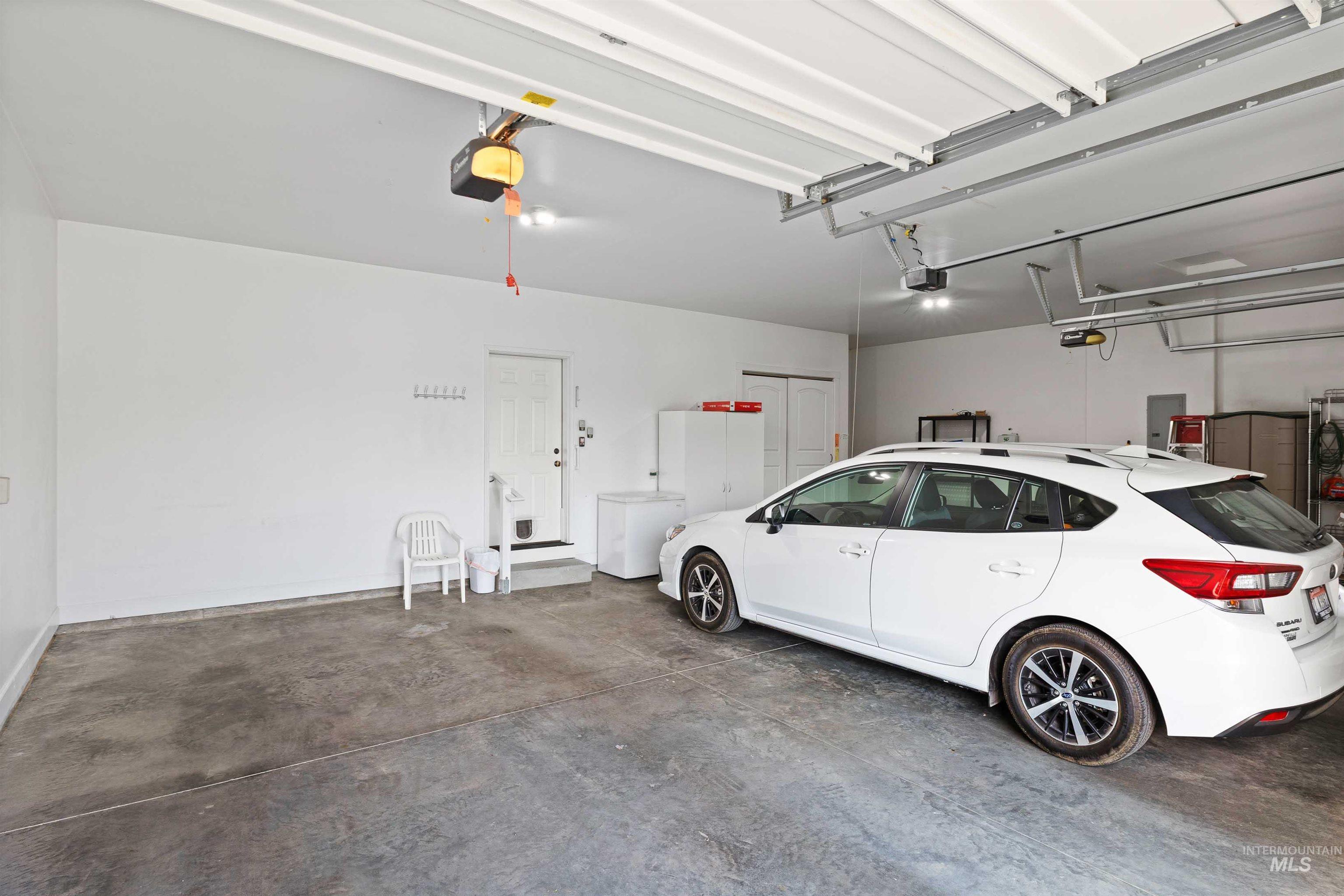 Garage with a garage door opener and electric panel