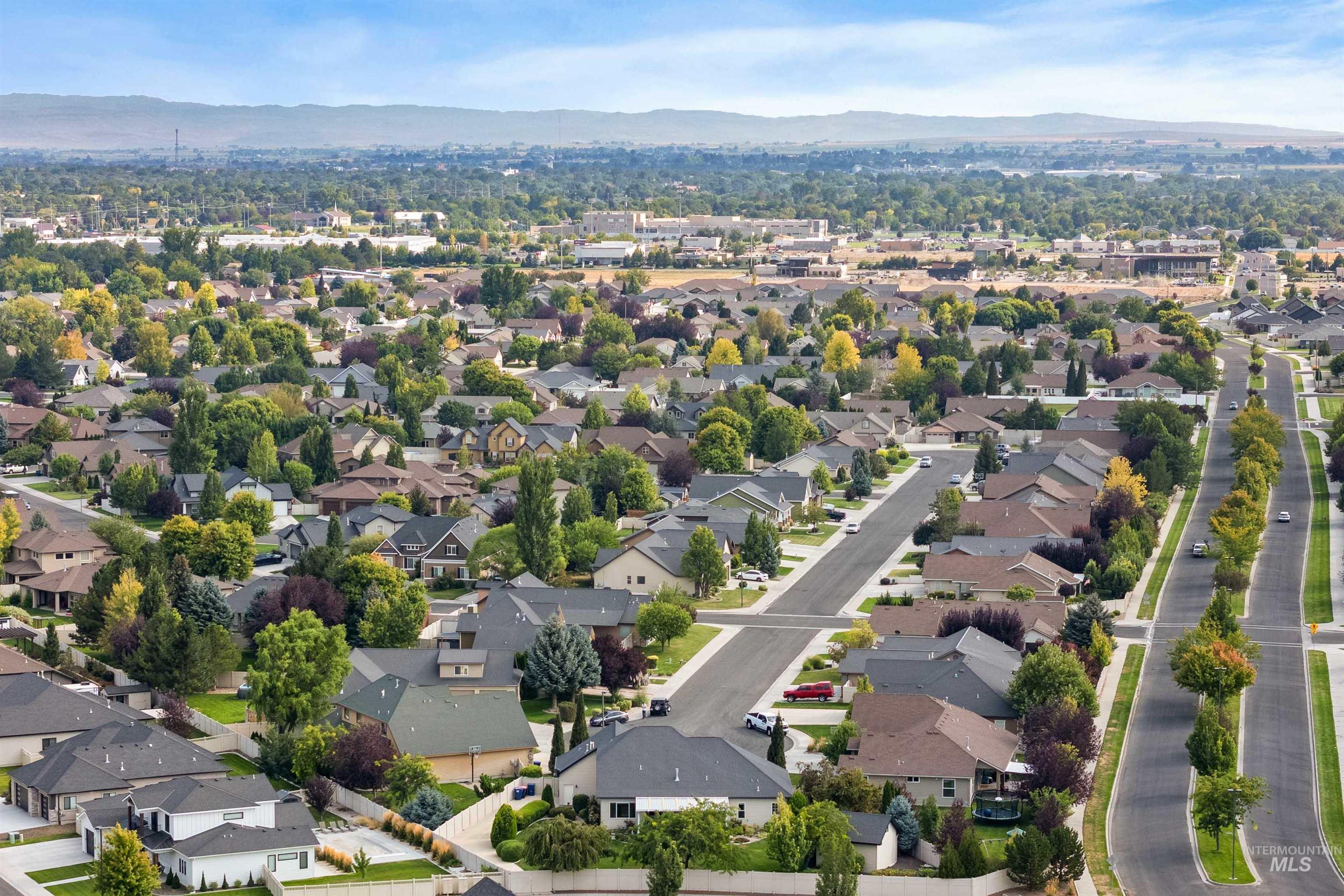 Aerial perspective of suburban area with a mountainous background
