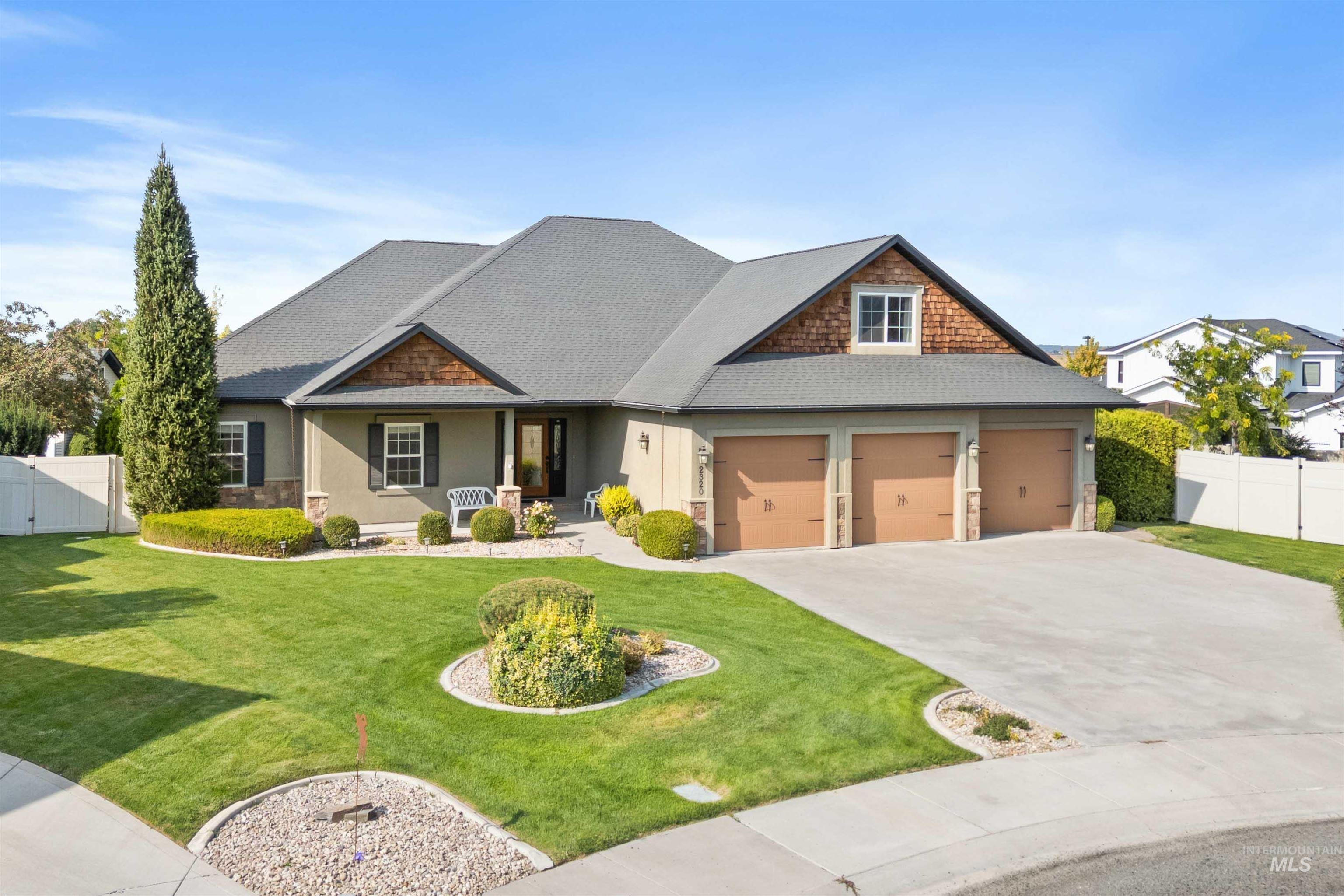 Craftsman house with a porch, concrete driveway, stucco siding, roof with shingles, and stone siding