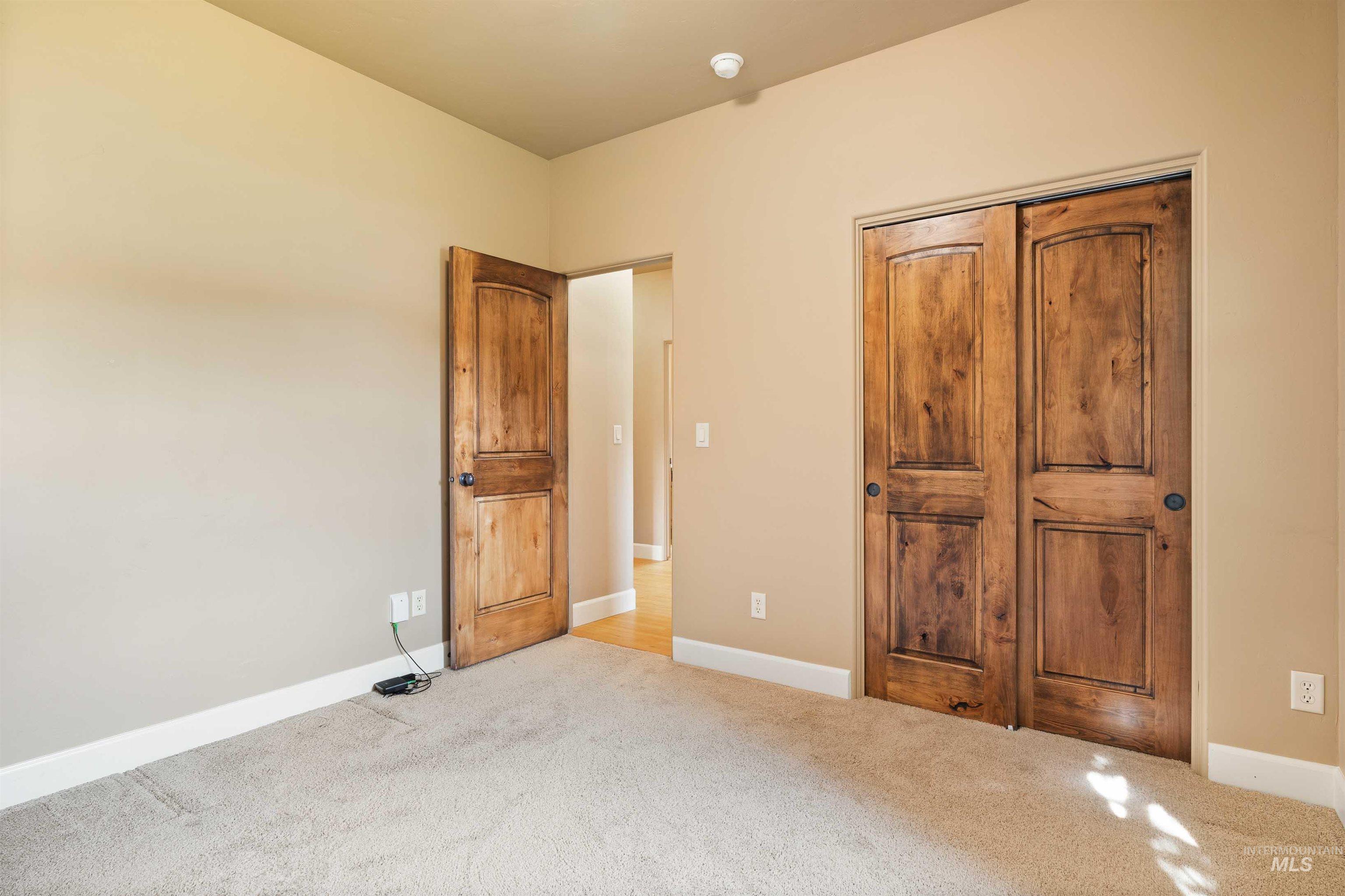 Unfurnished bedroom with baseboards and carpet