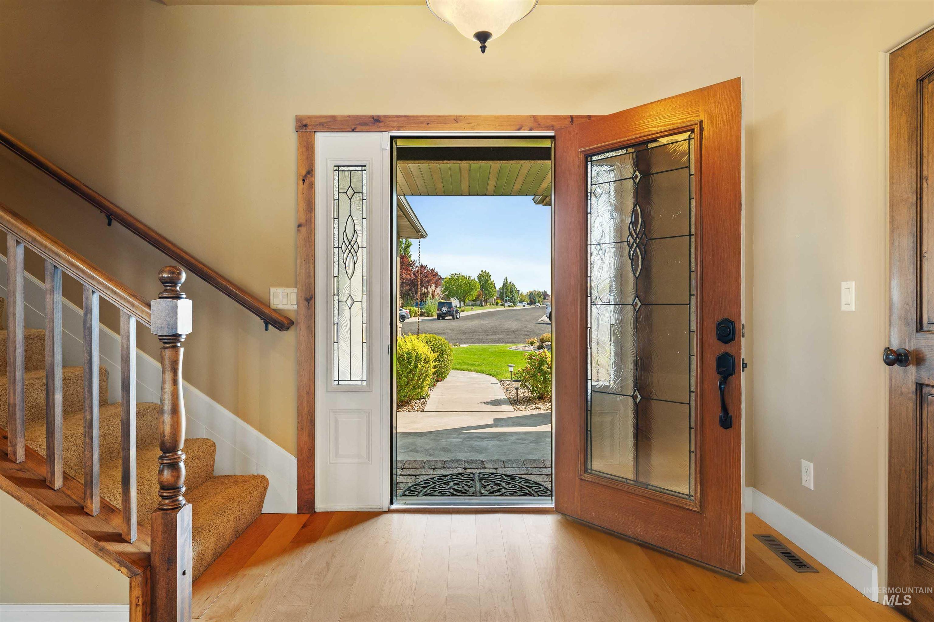 Entrance foyer with wood finished floors and stairs