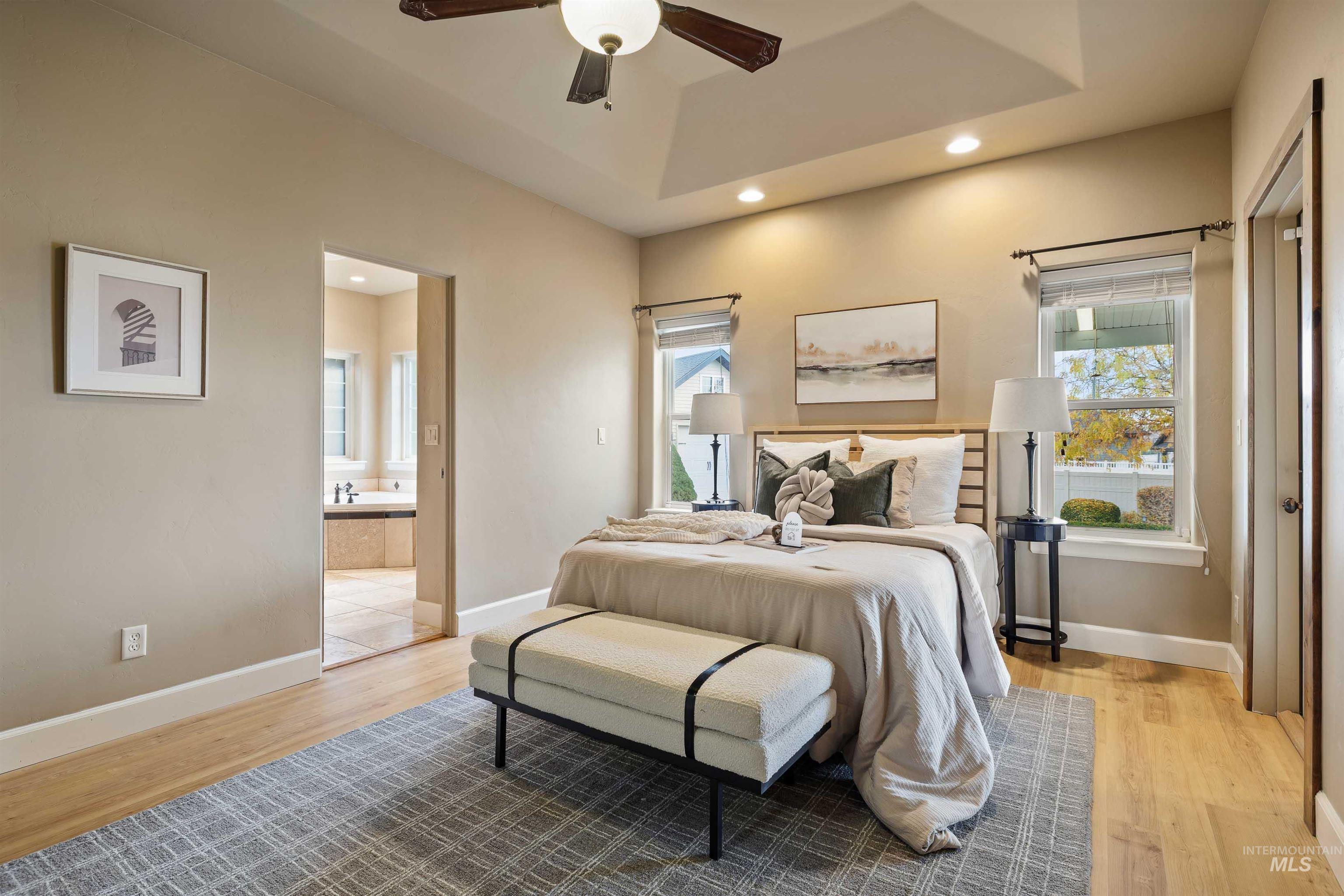 Bedroom featuring multiple windows, recessed lighting, and light wood-style flooring