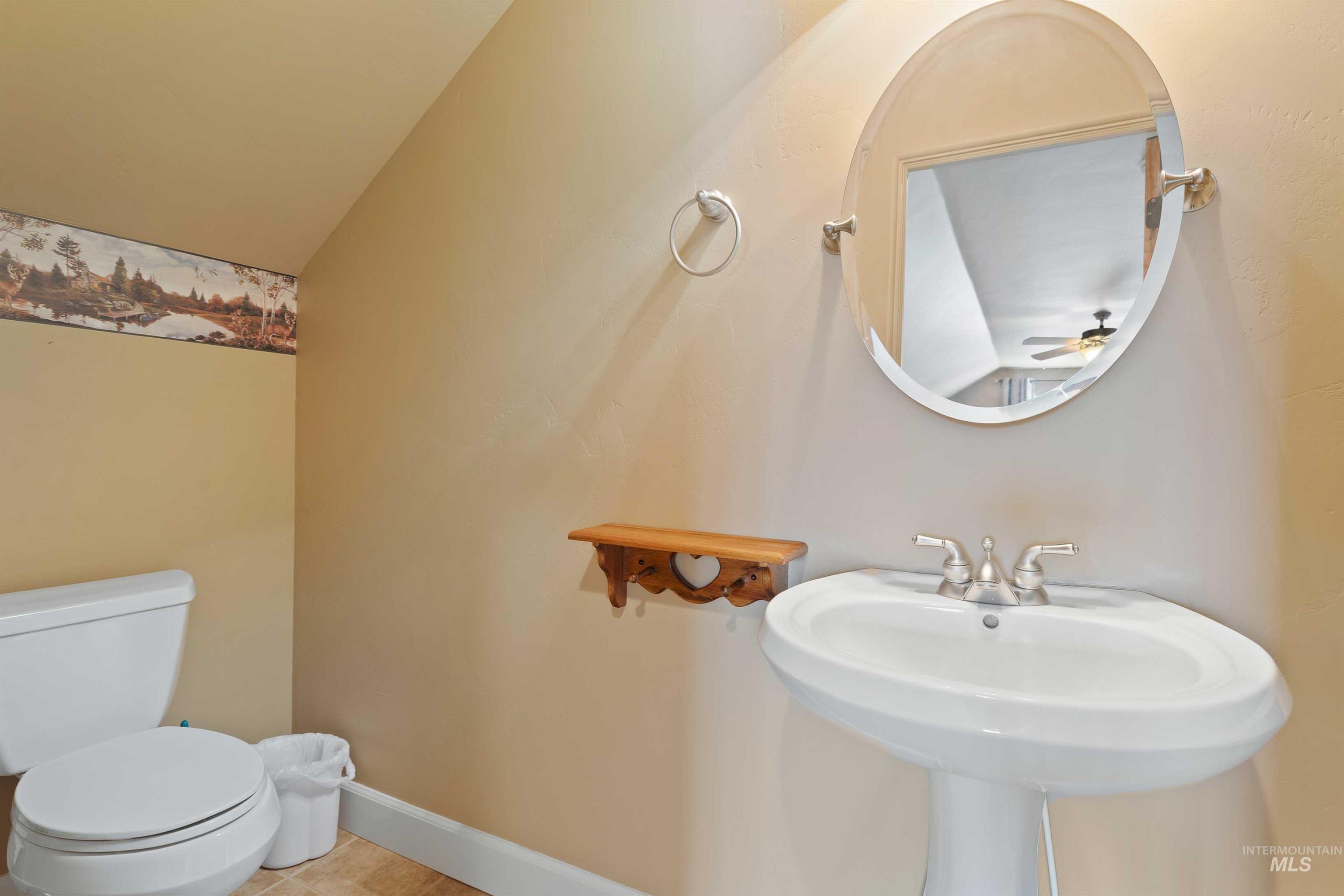 Bathroom with toilet and tile patterned flooring