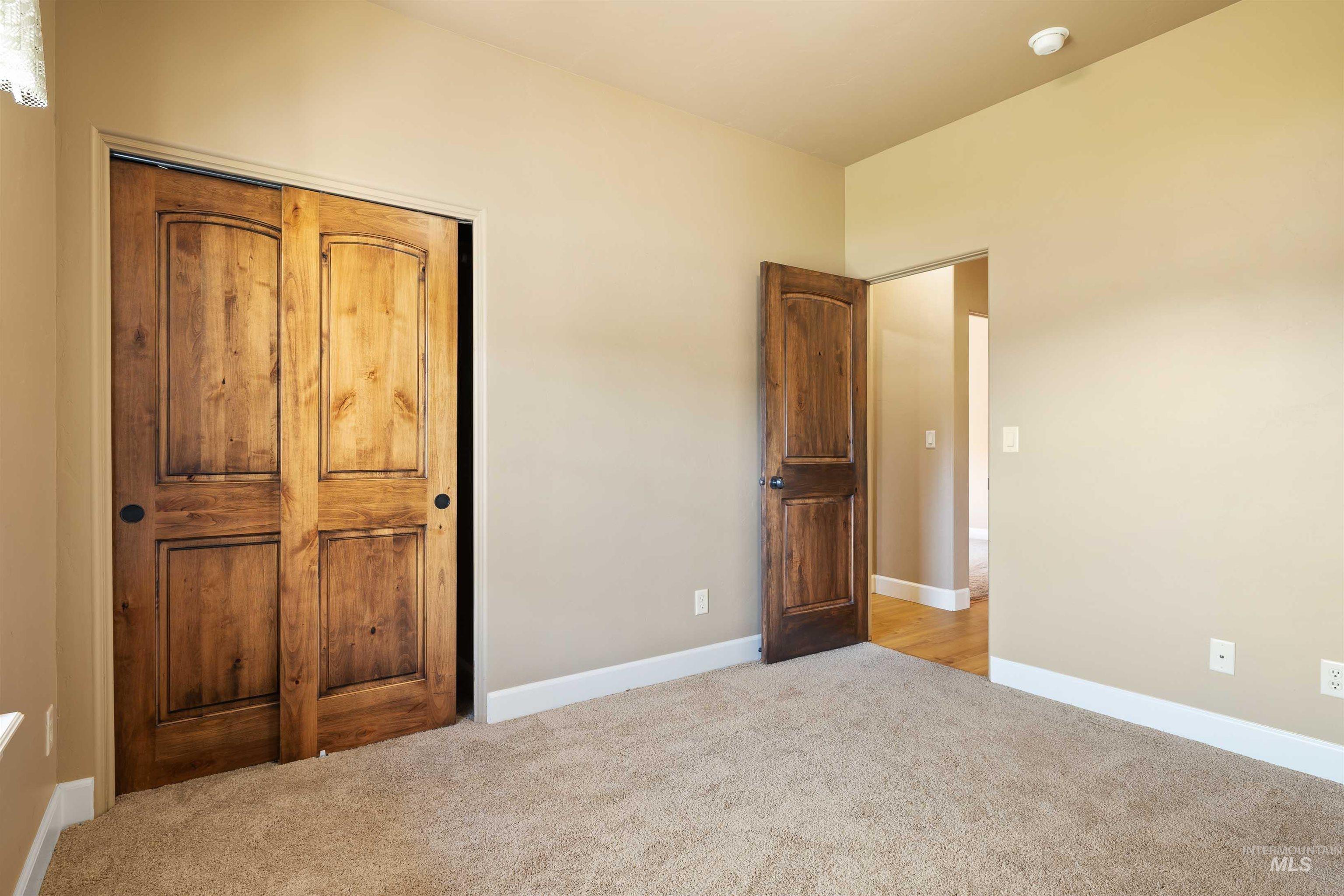 Unfurnished bedroom with baseboards and carpet floors