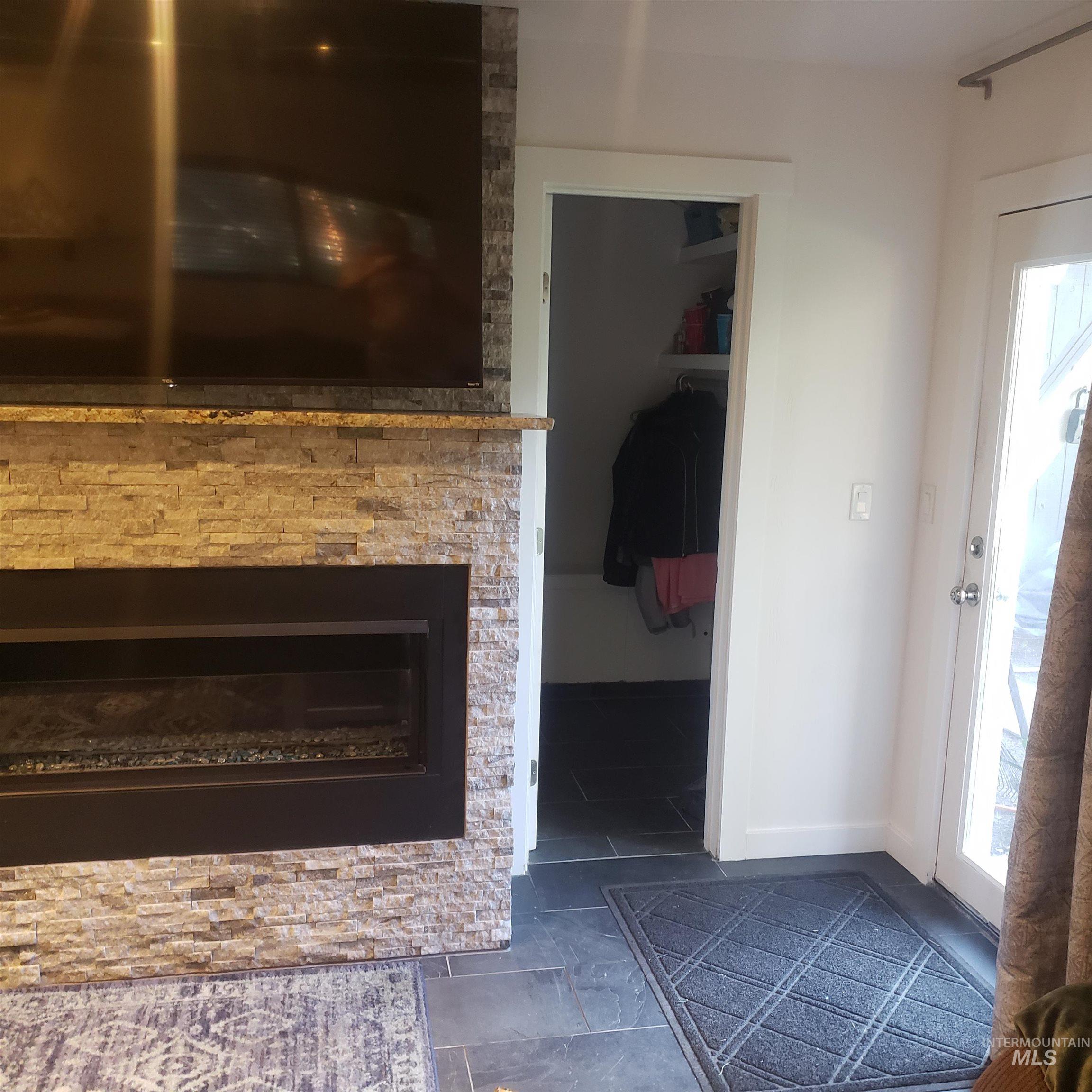 Detailed view of baseboards and a stone fireplace