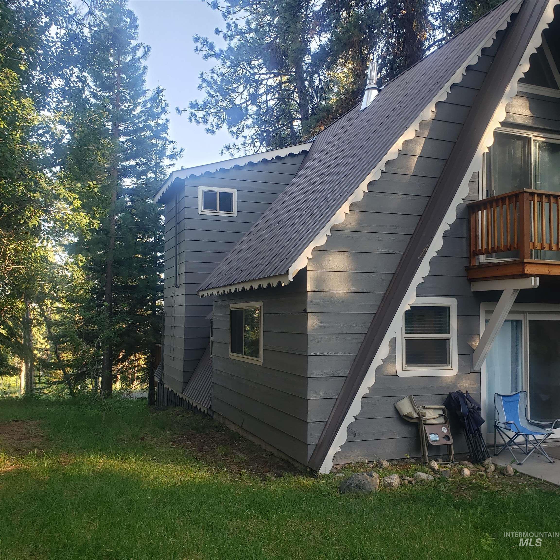 View of home's exterior with a metal roof and a balcony
