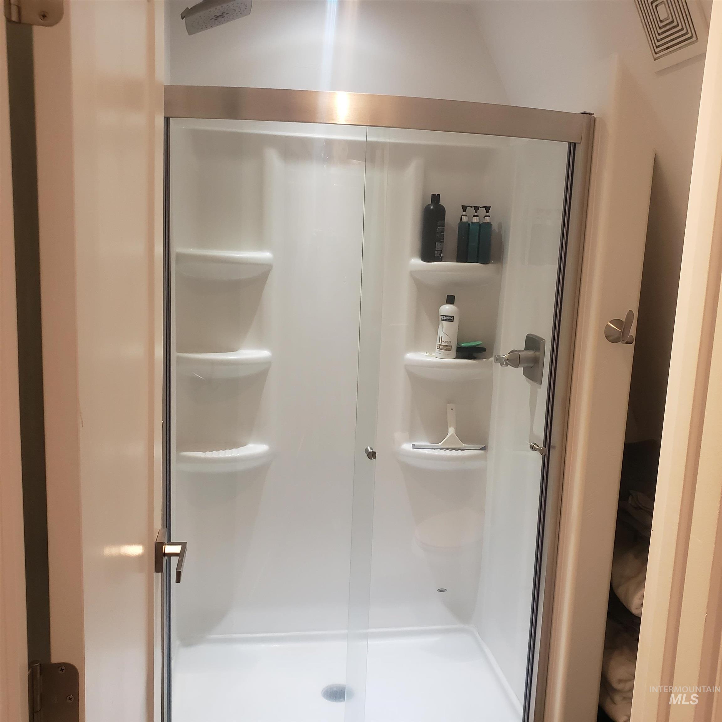 Bathroom featuring a shower stall