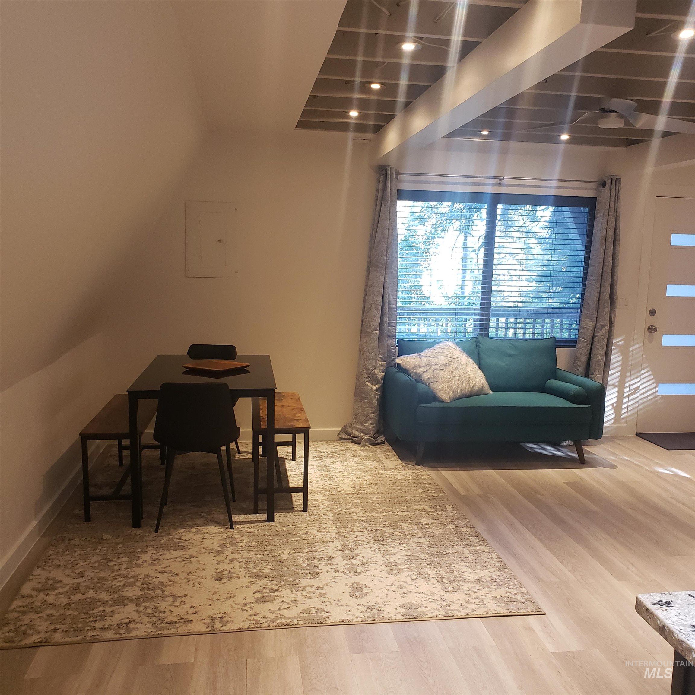 Living room featuring light wood-style floors and electric panel