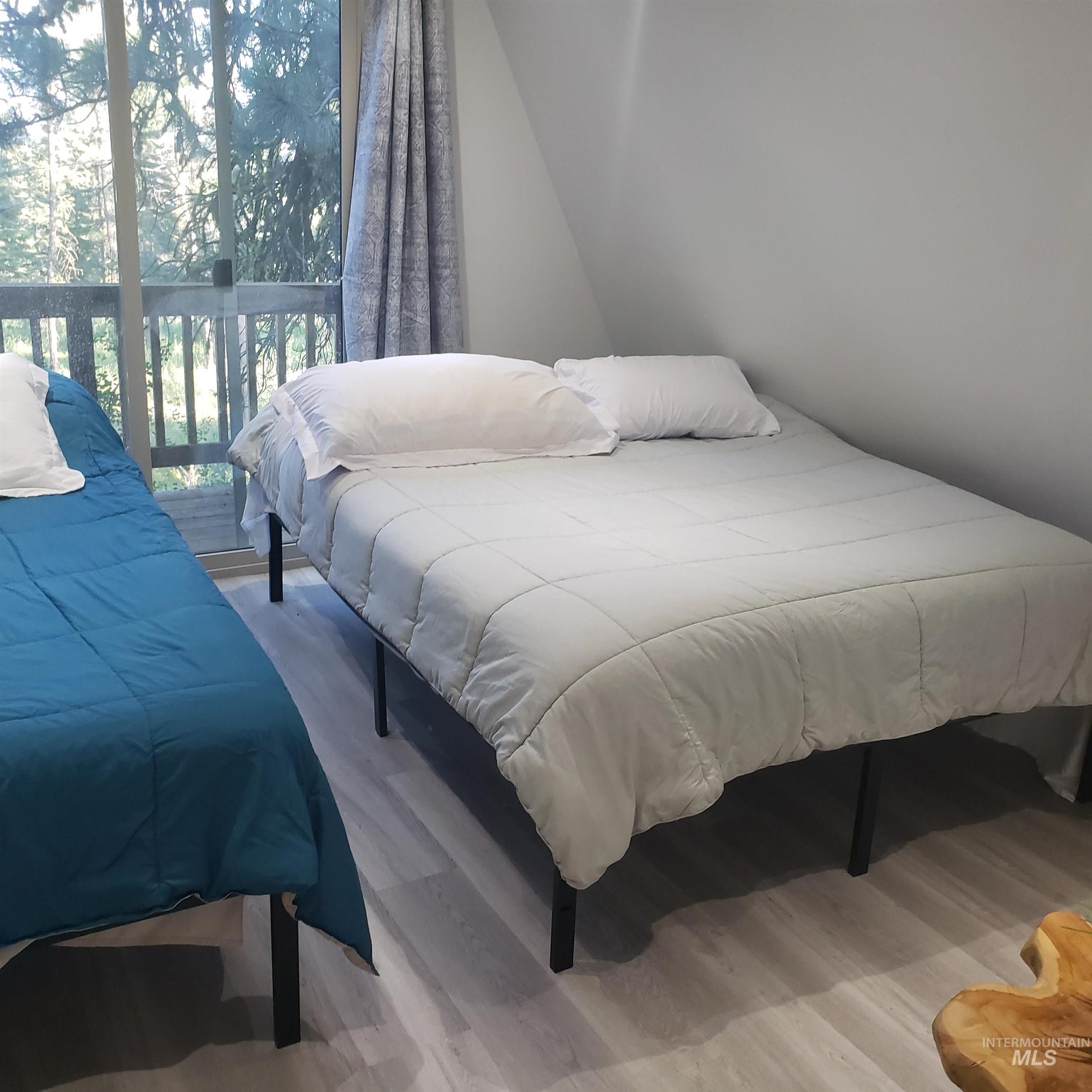 Bedroom with light wood-style floors and access to exterior