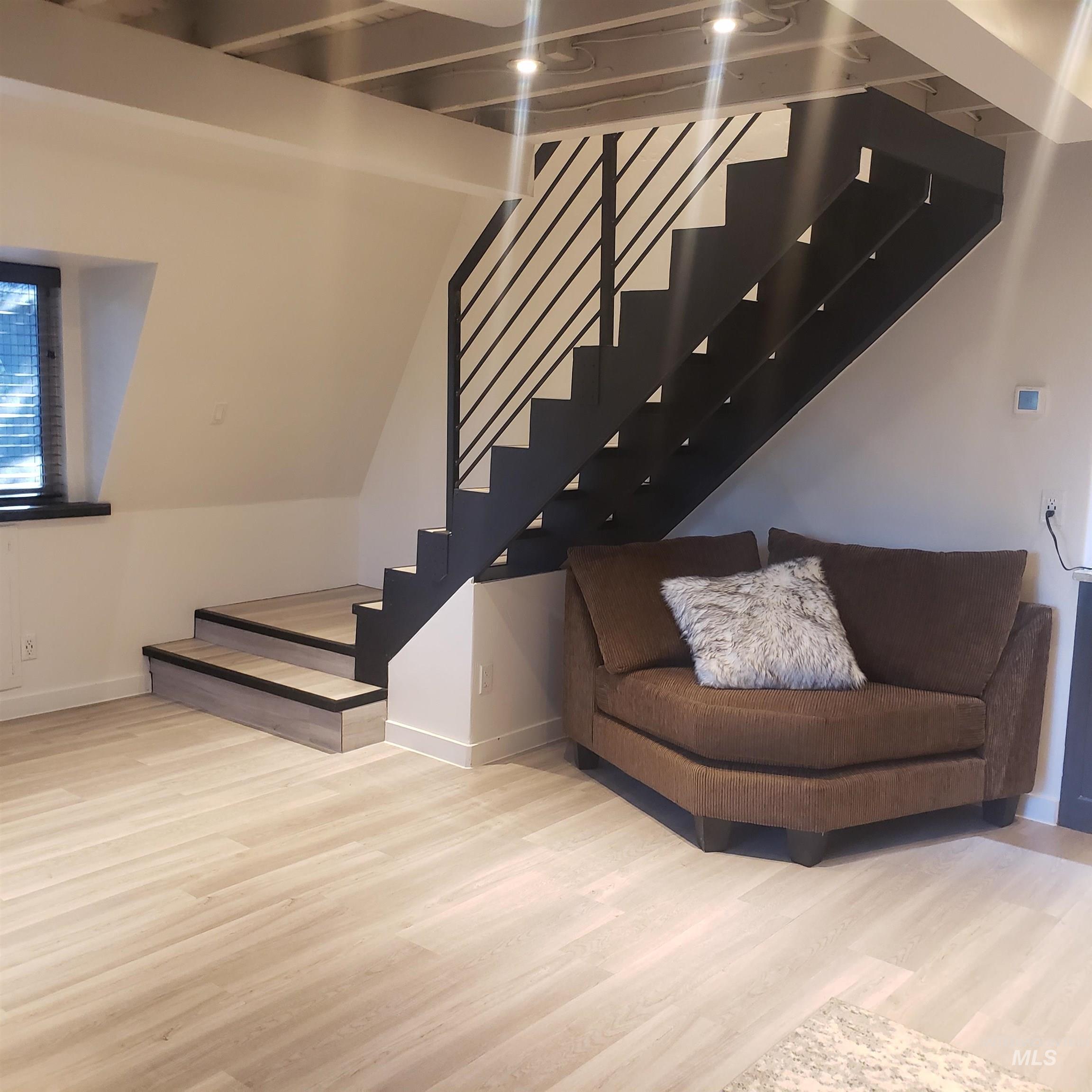 Staircase featuring wood finished floors and baseboards