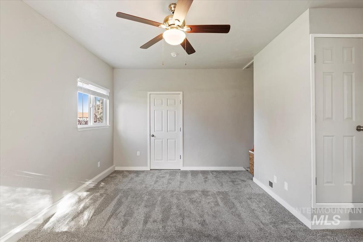 Unfurnished bedroom featuring carpet floors and a ceiling fan