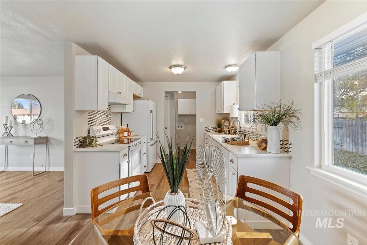 Dining room with light wood-style floors and baseboards