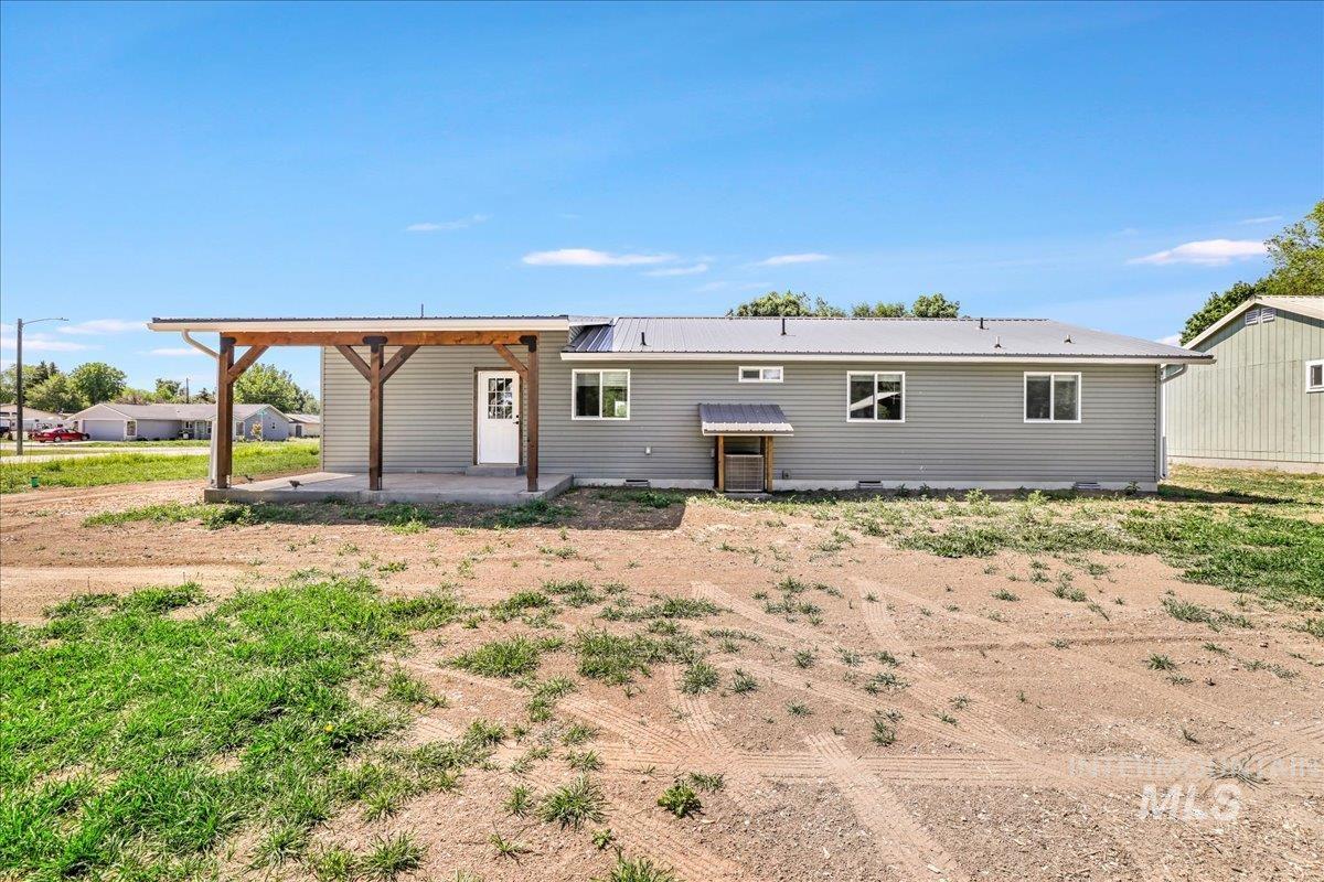 Back of property with a patio and a metal roof
