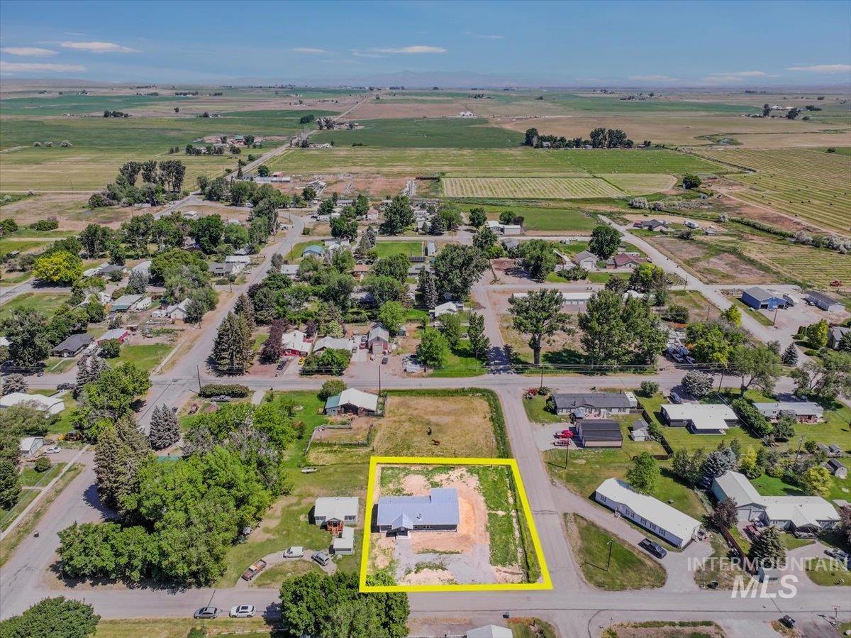 Aerial view of sparsely populated area featuring rows of crops and property boundaries highlighted