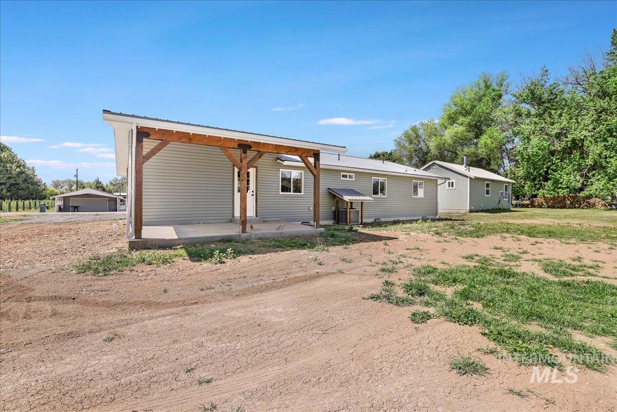Back of property featuring a metal roof