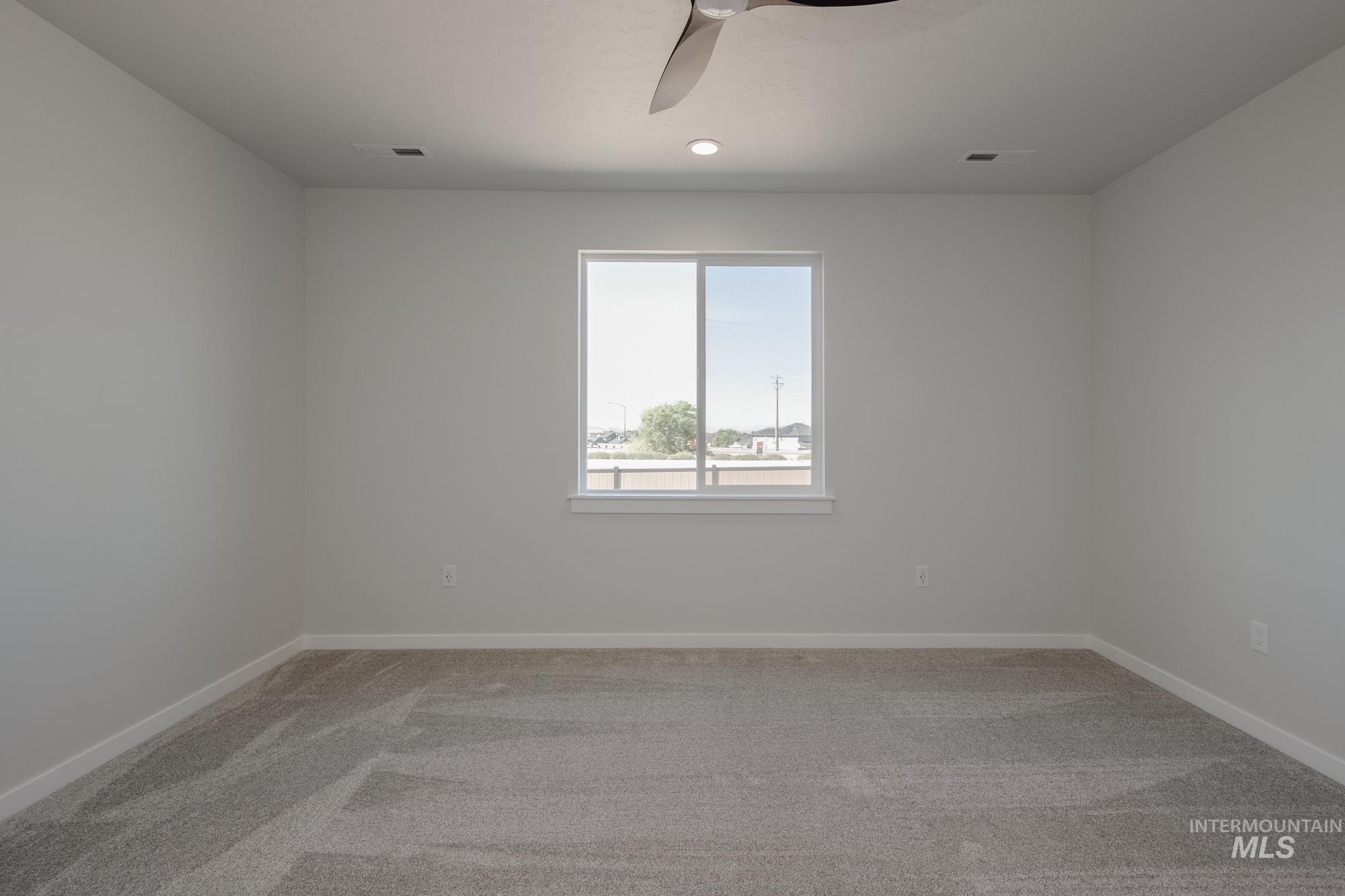 Empty room with light colored carpet, a ceiling fan, and recessed lighting