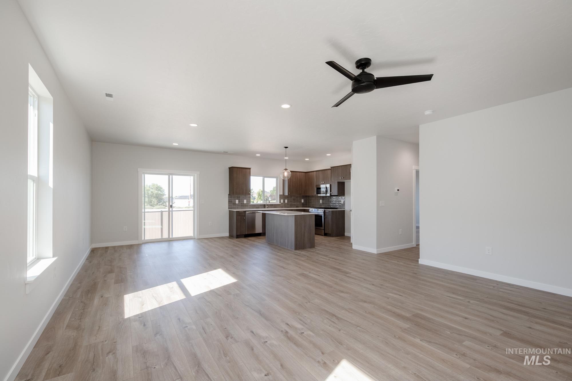Unfurnished living room featuring recessed lighting, light wood-style floors, and a ceiling fan