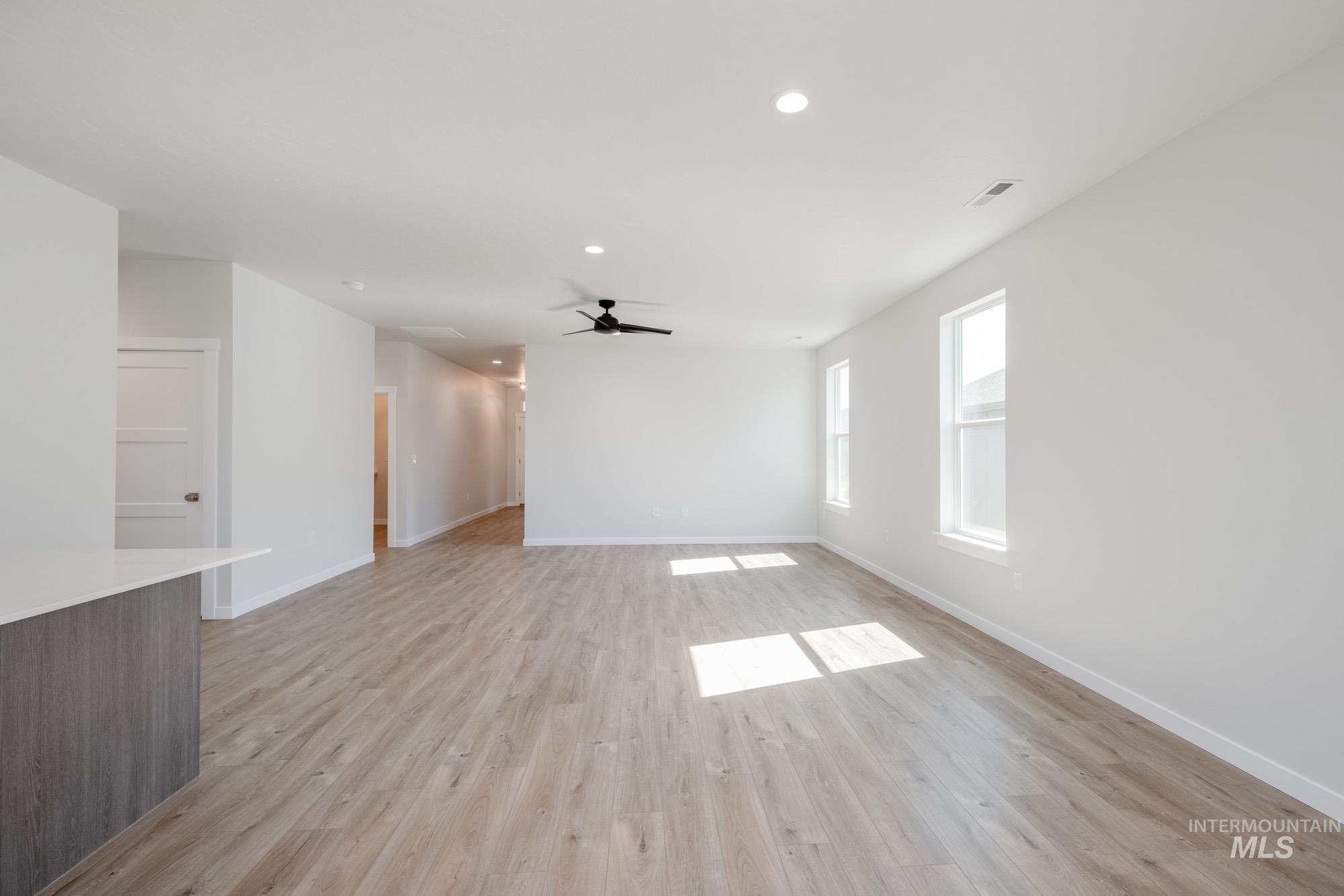 Unfurnished living room featuring recessed lighting, light wood-type flooring, and ceiling fan
