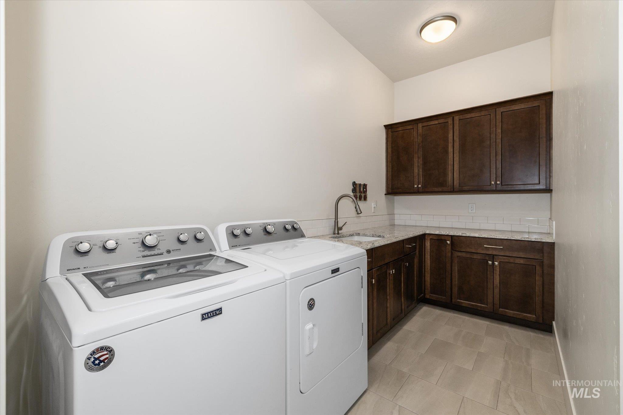 Laundry room with washer and dryer and cabinet space