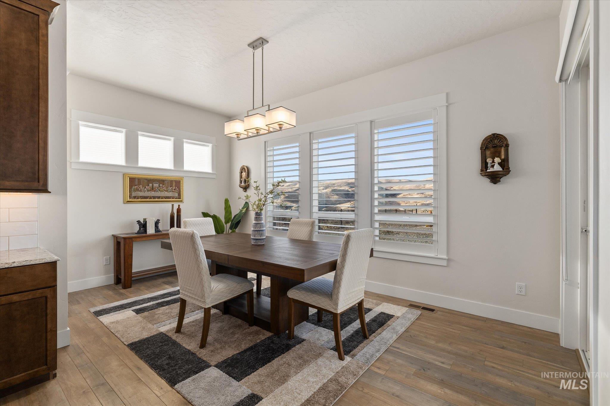 Dining space featuring light wood-style flooring and baseboards