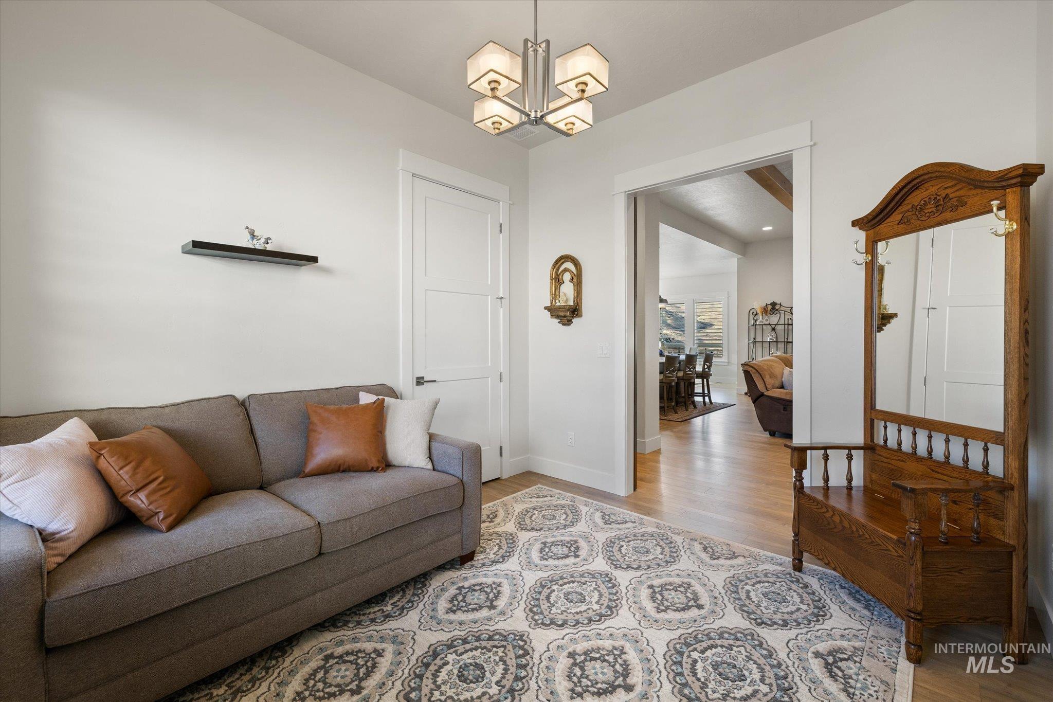Living room with wood finished floors and a chandelier
