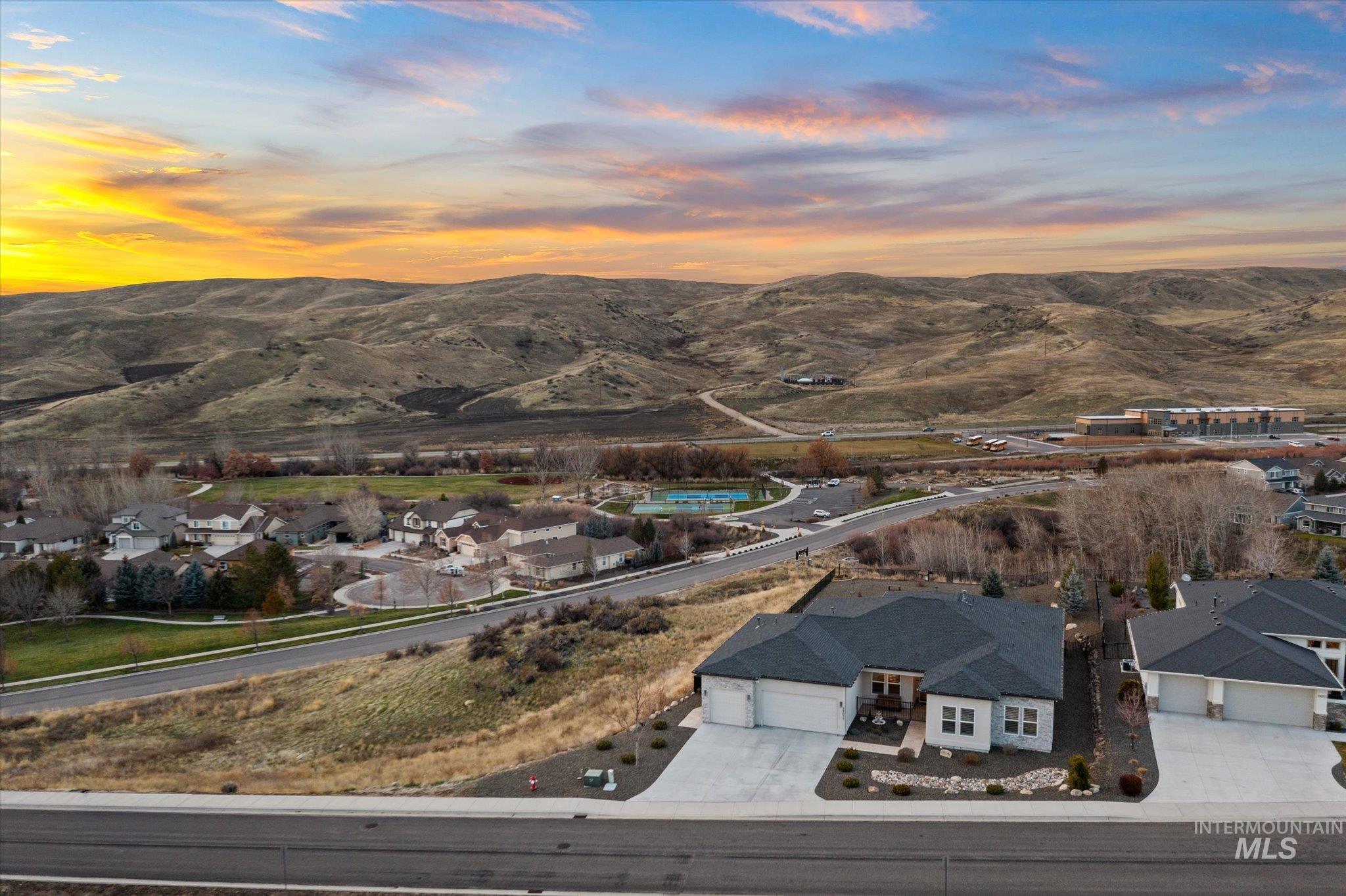 View of mountain backdrop featuring nearby suburban area