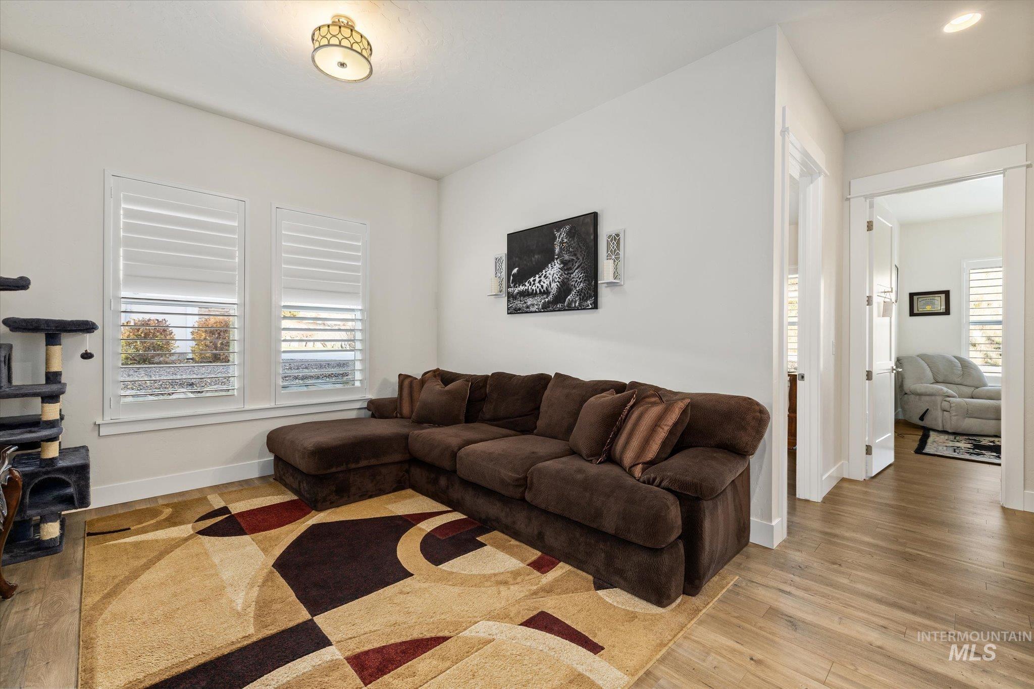 Living area with healthy amount of natural light and light wood-type flooring