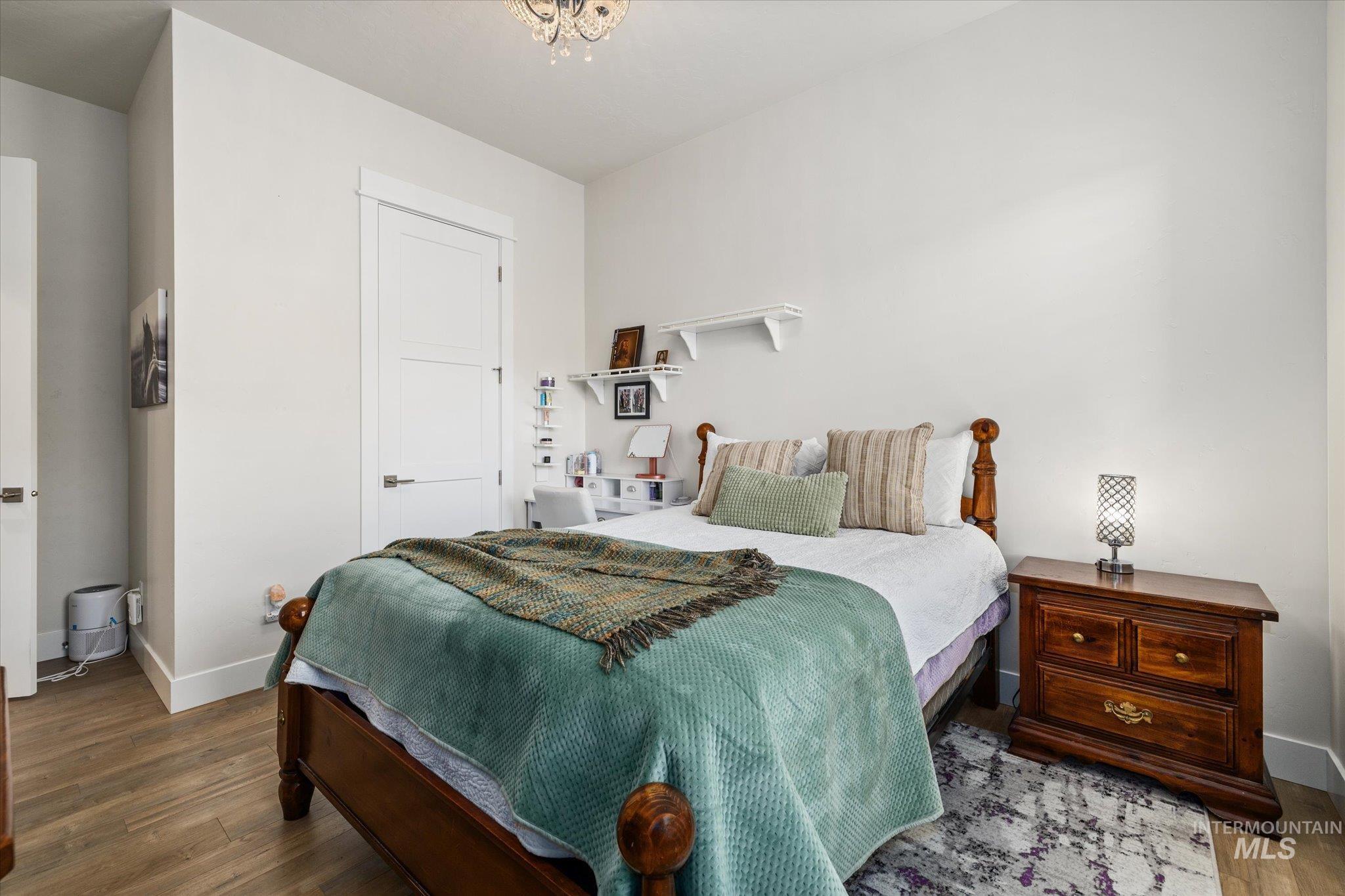 Bedroom featuring dark wood finished floors and a closet