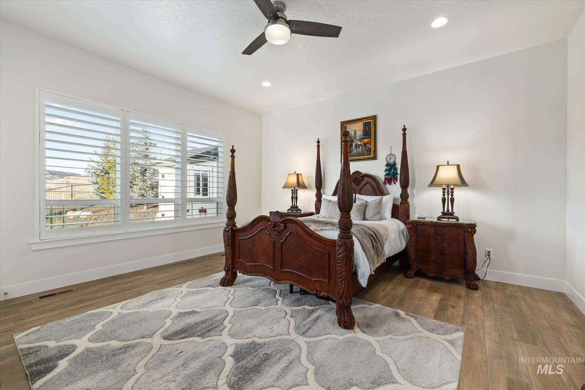 Bedroom featuring dark wood finished floors, ceiling fan, and recessed lighting