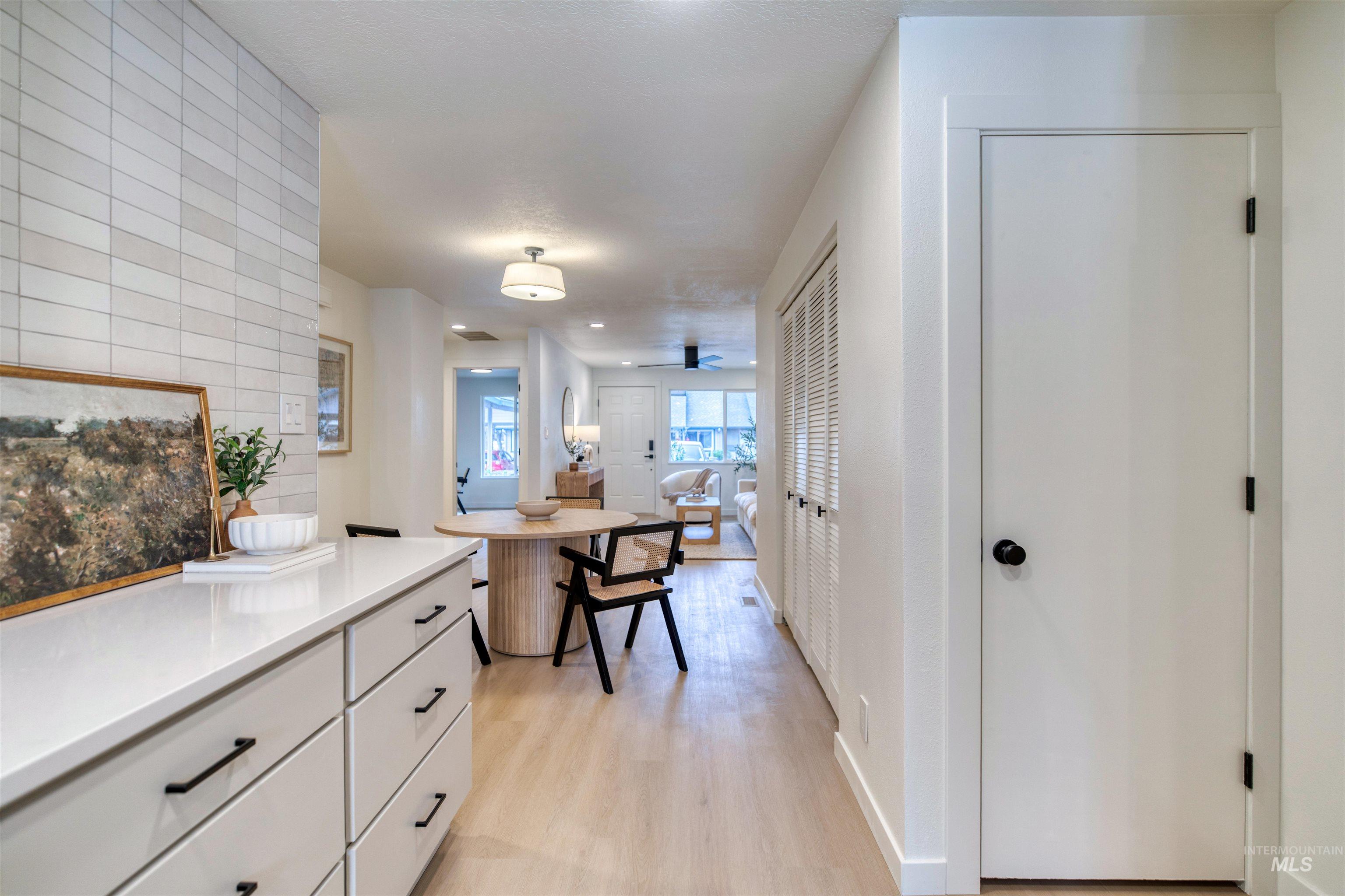 Hall featuring light wood finished floors and baseboards