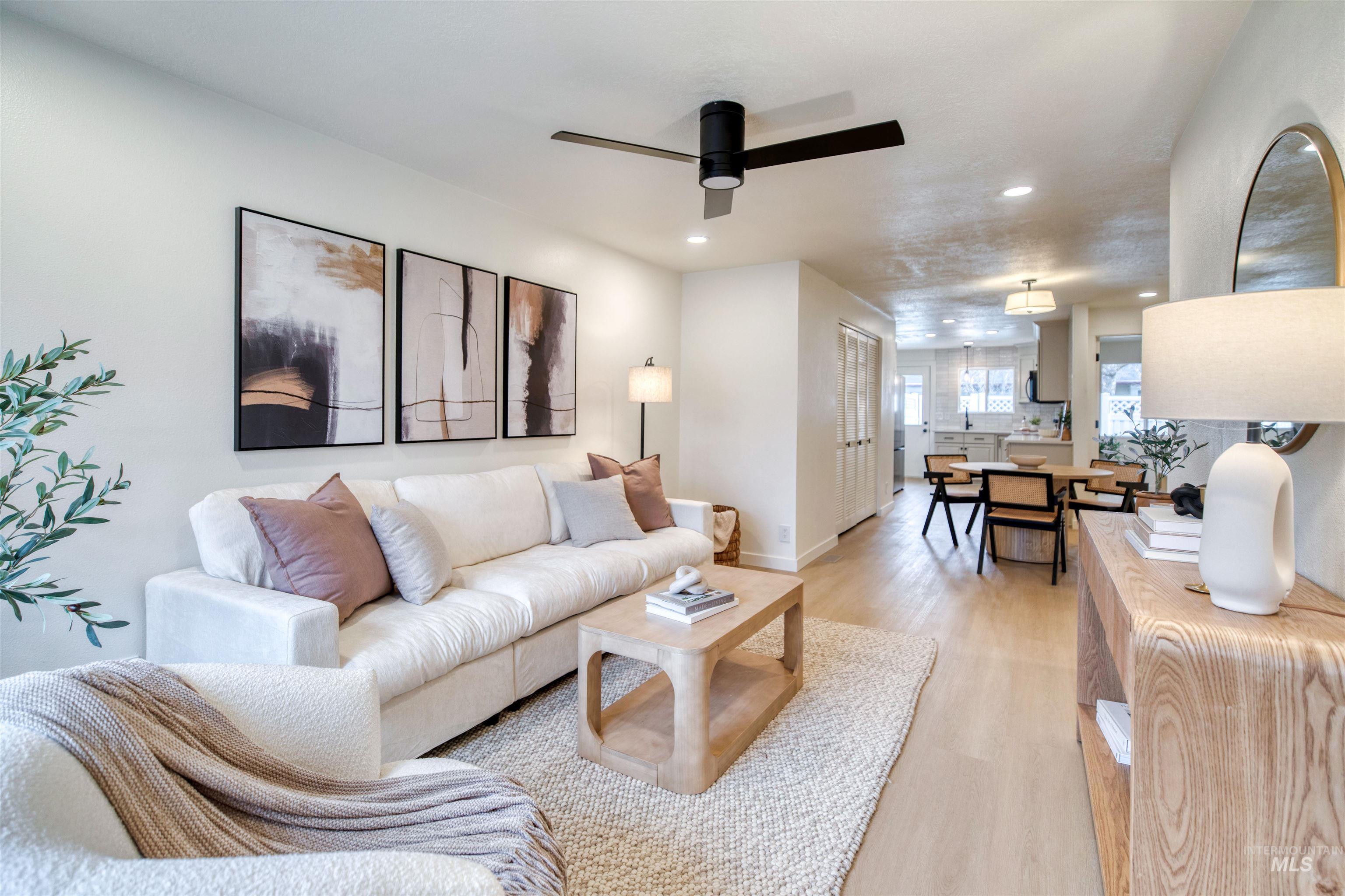 Living room featuring recessed lighting, light wood-type flooring, and a ceiling fan