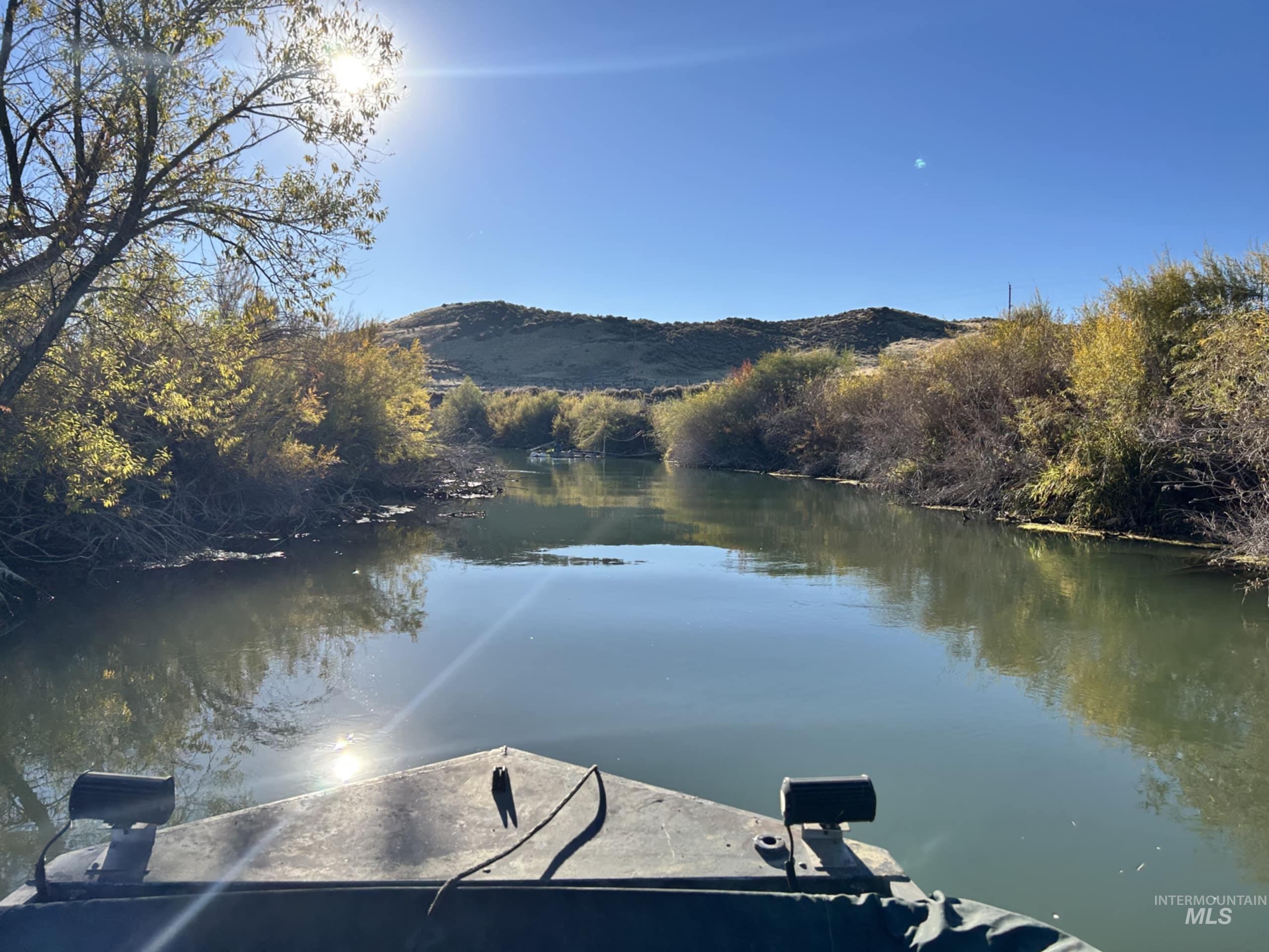 Dock area featuring a water and mountain view and a wooded view
