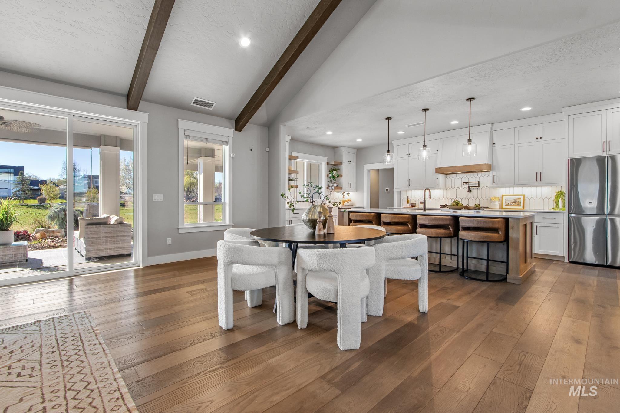 Dining space with dark wood-type flooring and recessed lighting