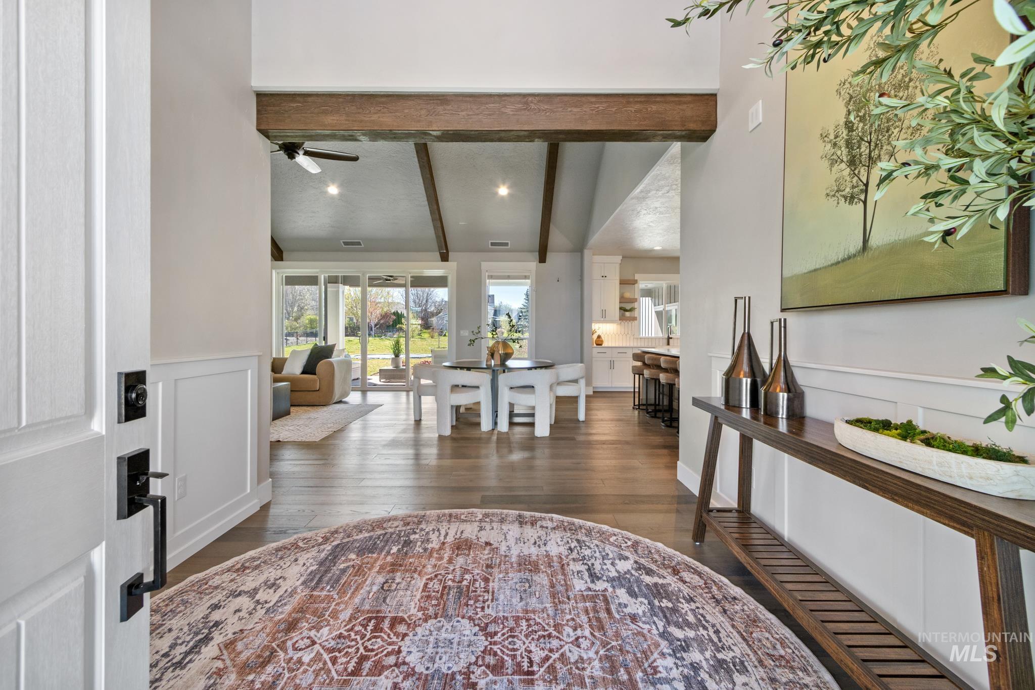 Entryway featuring dark wood-style floors, a ceiling fan, and lofted ceiling