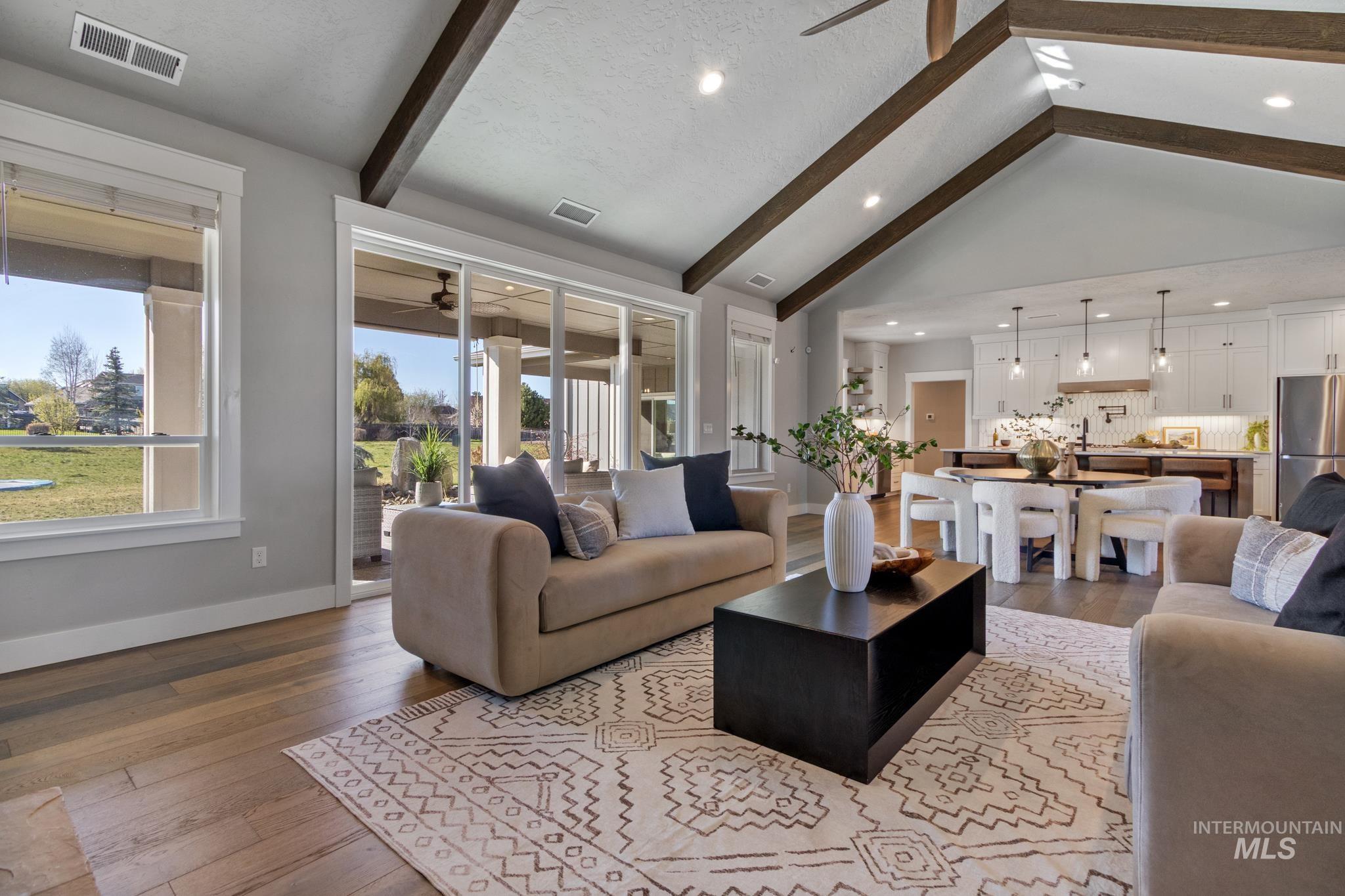 Living area featuring dark wood-style flooring, a ceiling fan, and recessed lighting