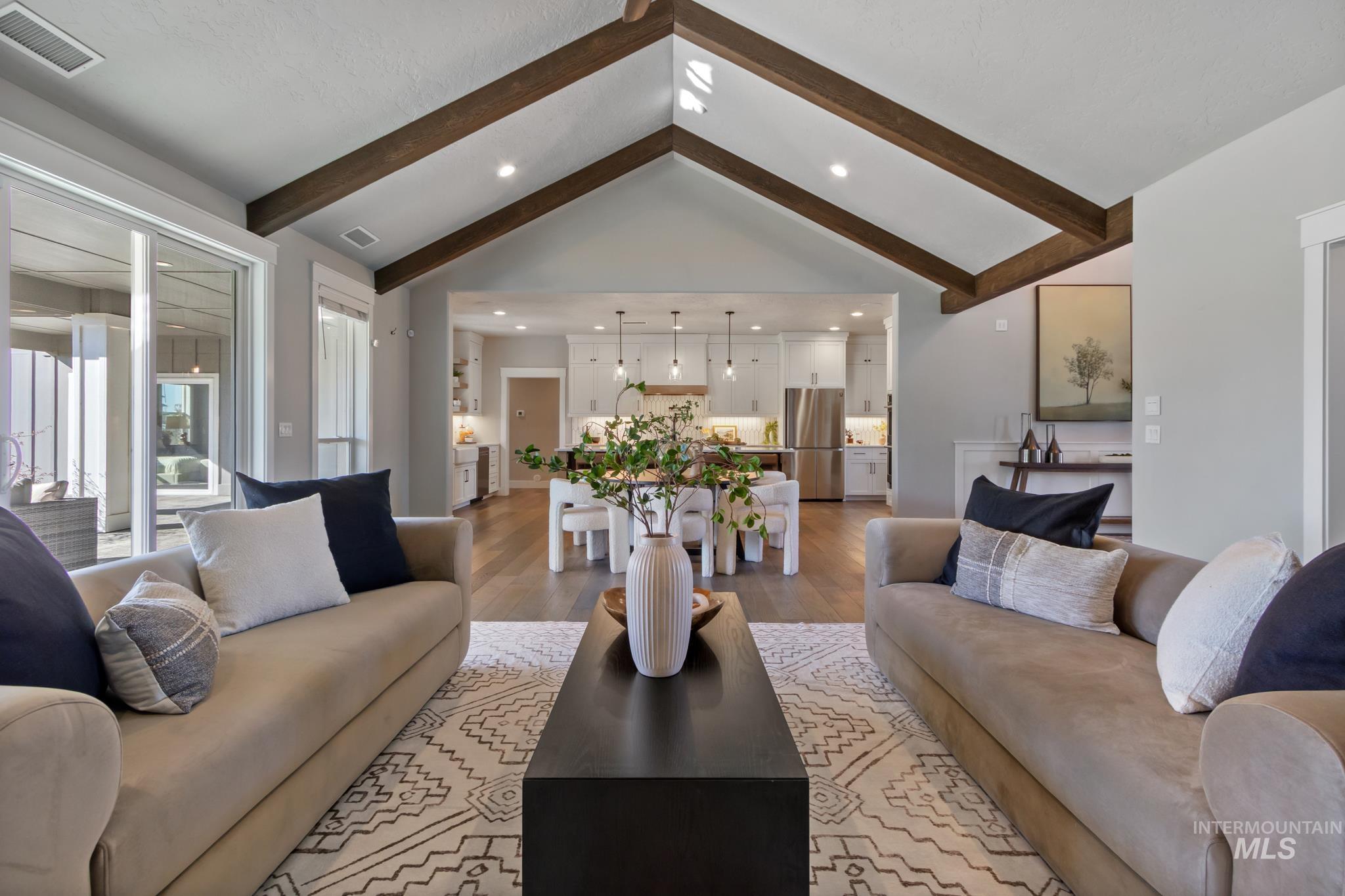 Living area with light wood-style floors and recessed lighting