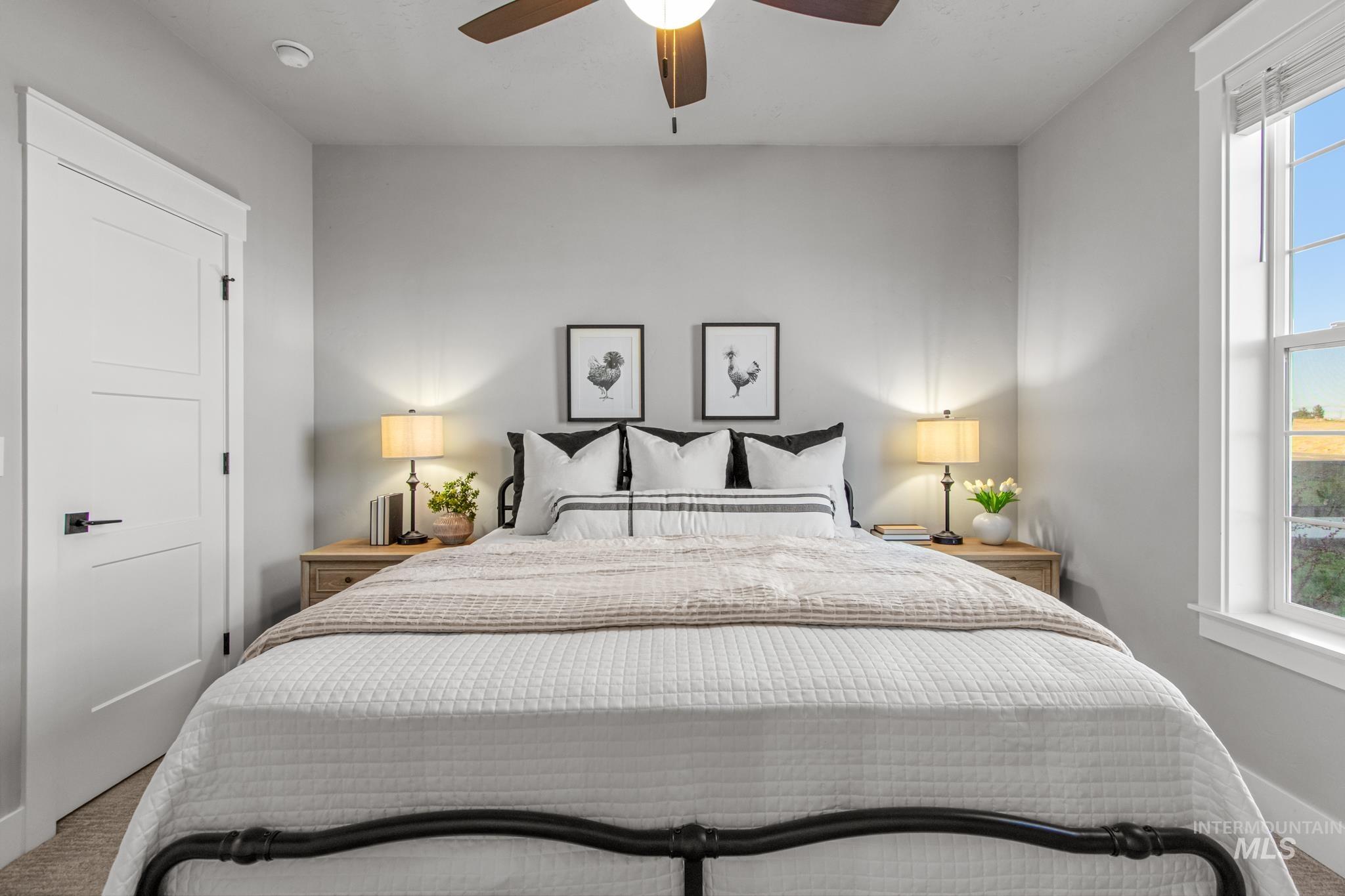 Bedroom featuring ceiling fan, carpet floors, and multiple windows