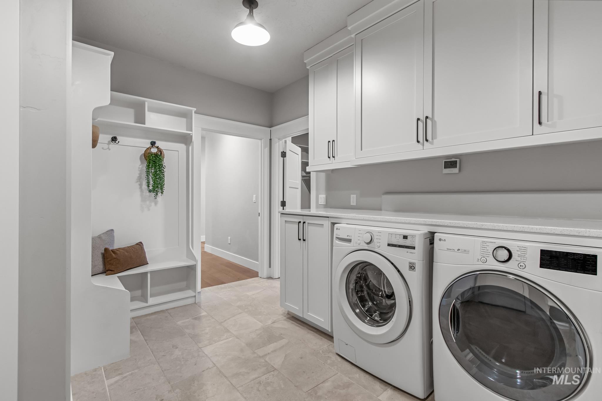 Laundry room with washing machine and clothes dryer and cabinet space
