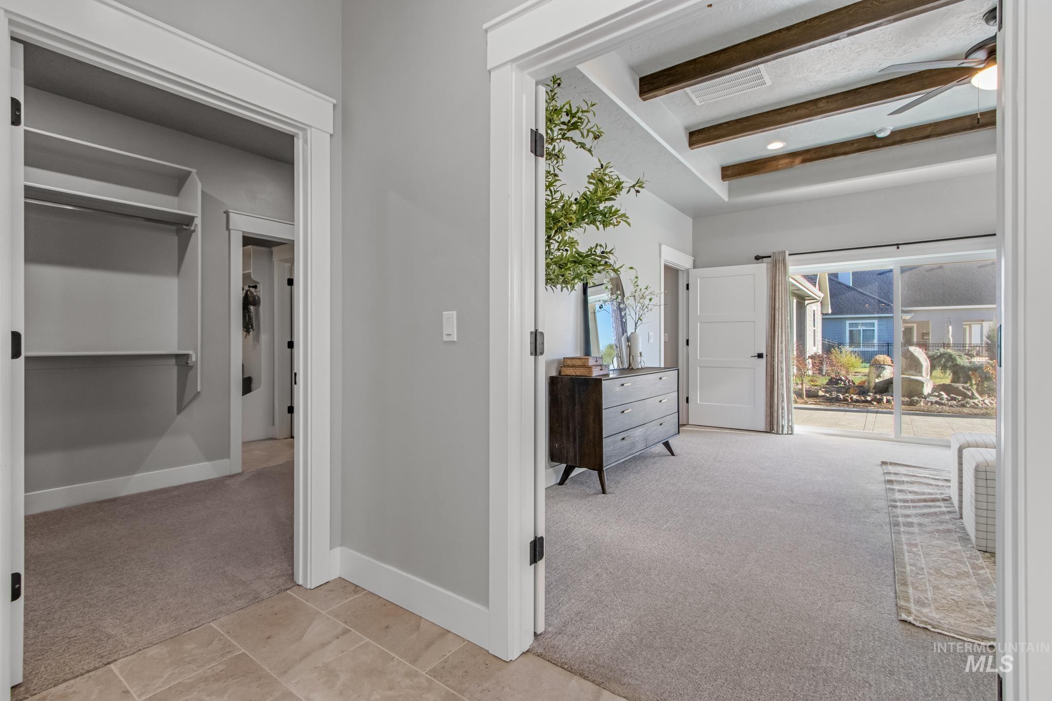 Hallway featuring light colored carpet, beamed ceiling, and recessed lighting