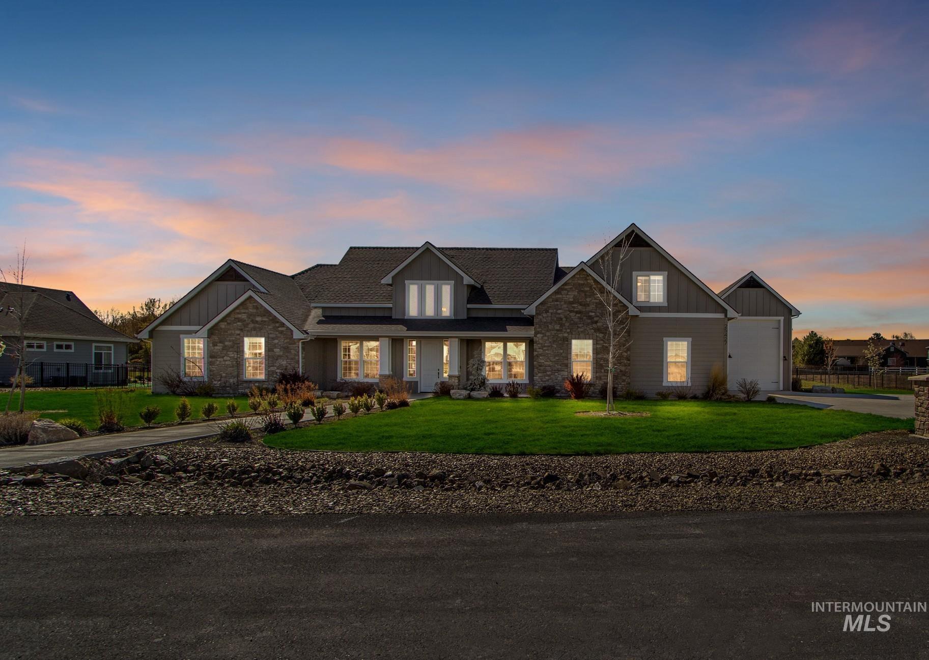 Craftsman-style home featuring board and batten siding, stone siding, a yard, and a porch