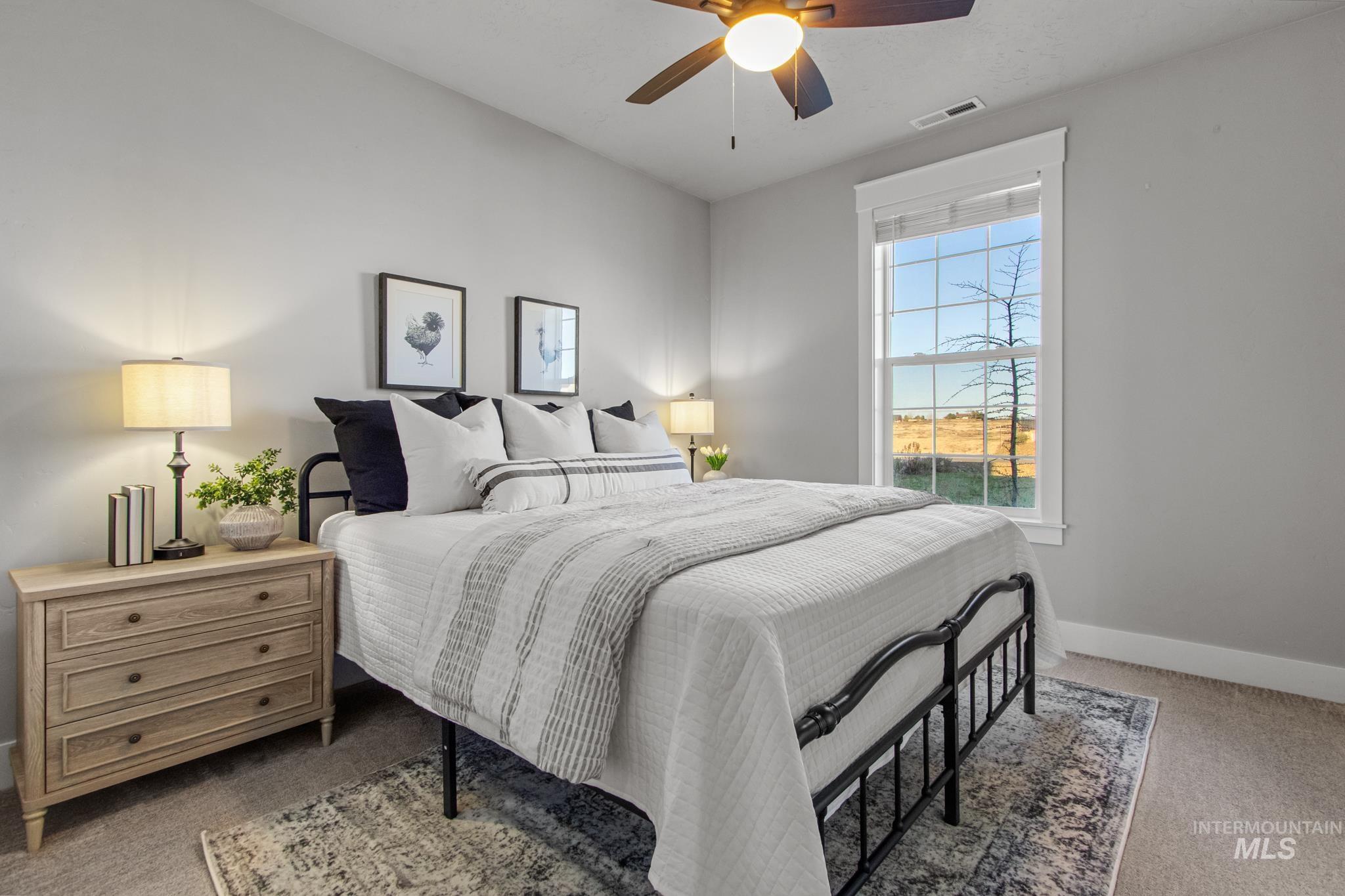 Bedroom with light colored carpet and ceiling fan