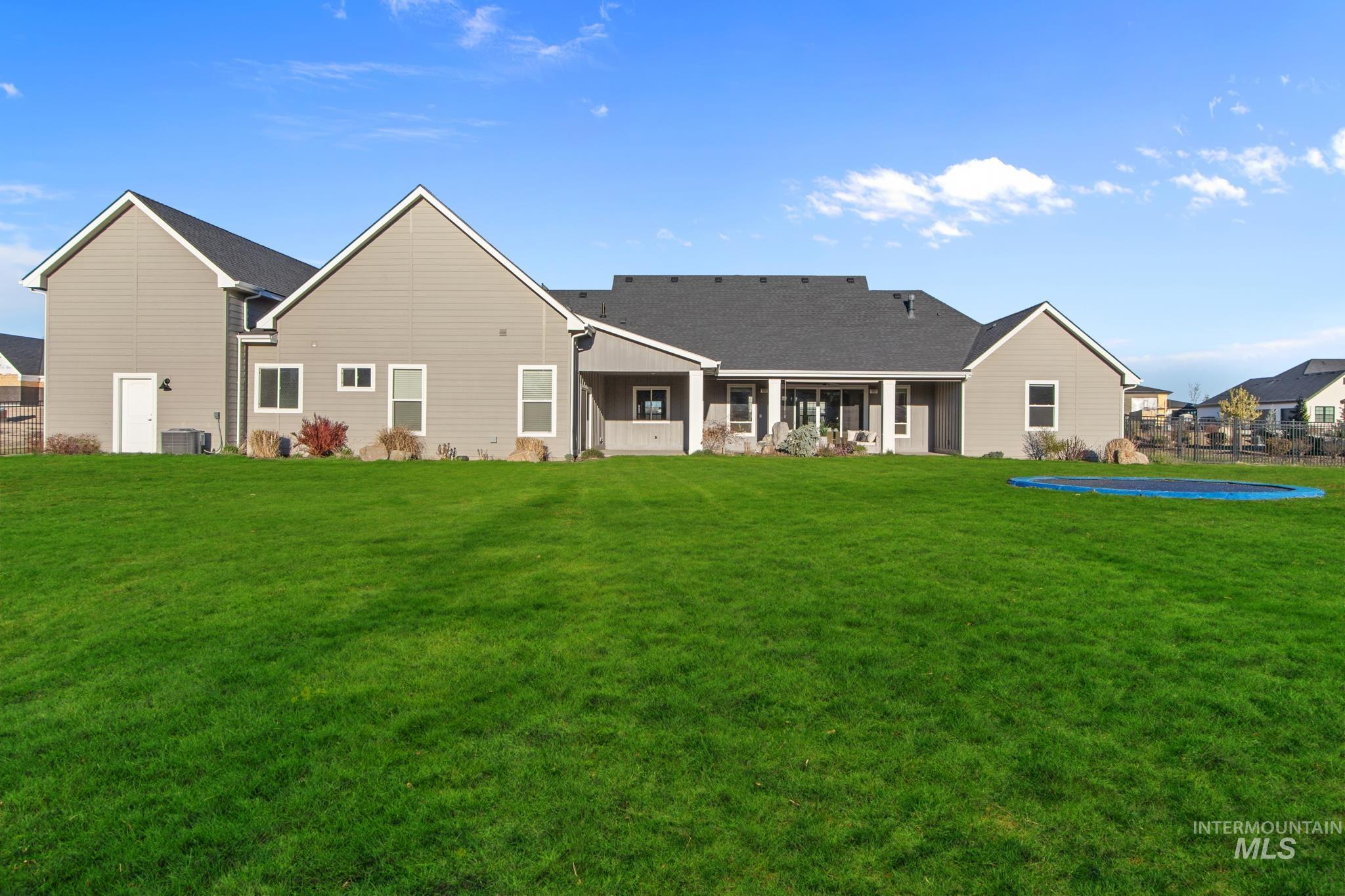 Back of property featuring a patio and roof with shingles