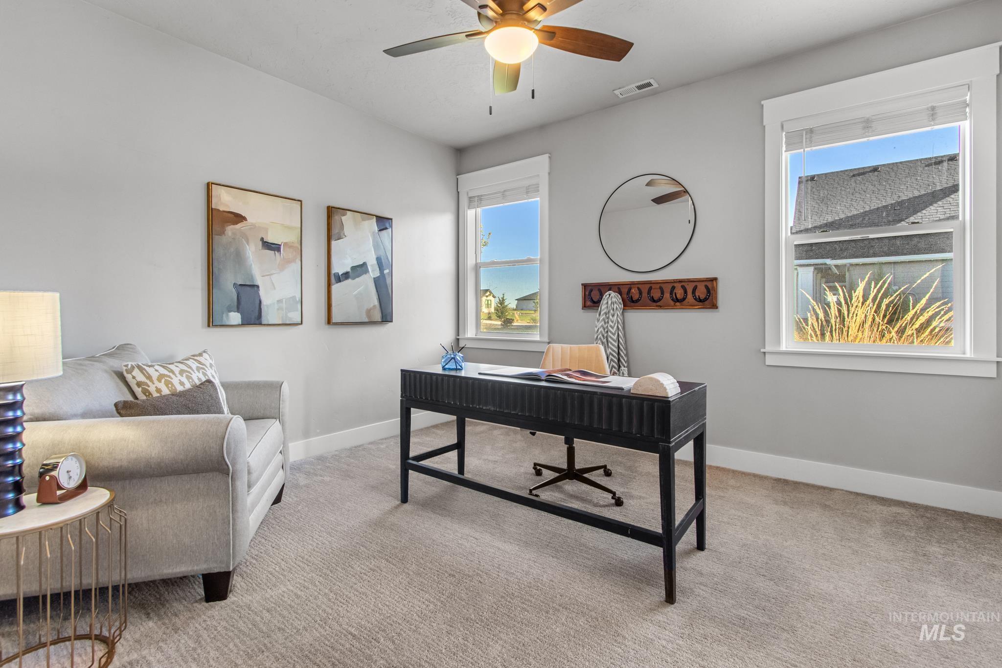 Office featuring light colored carpet and a ceiling fan