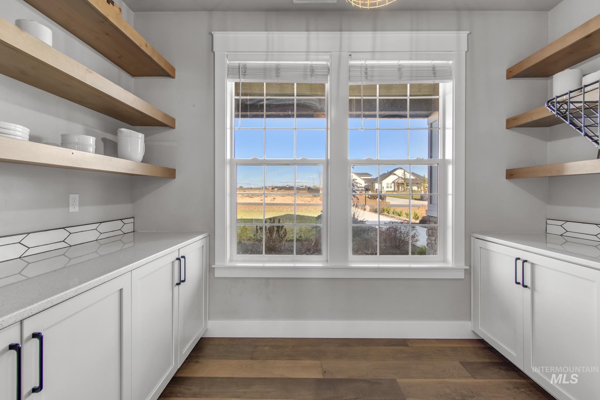 Interior space with dark wood-style floors and baseboards