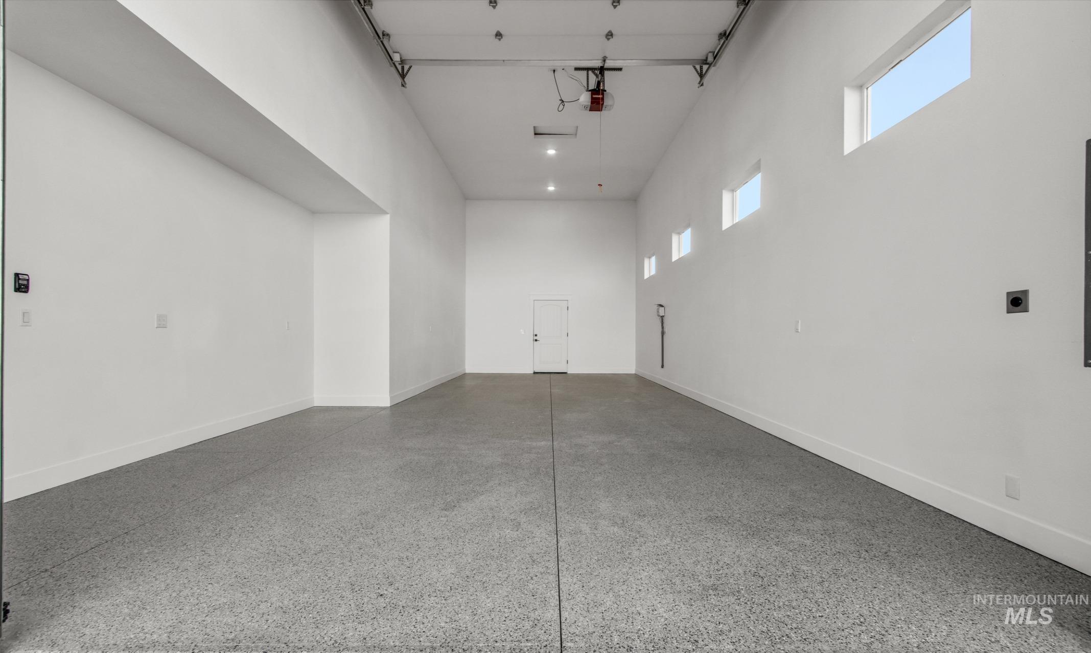 Garage featuring baseboards