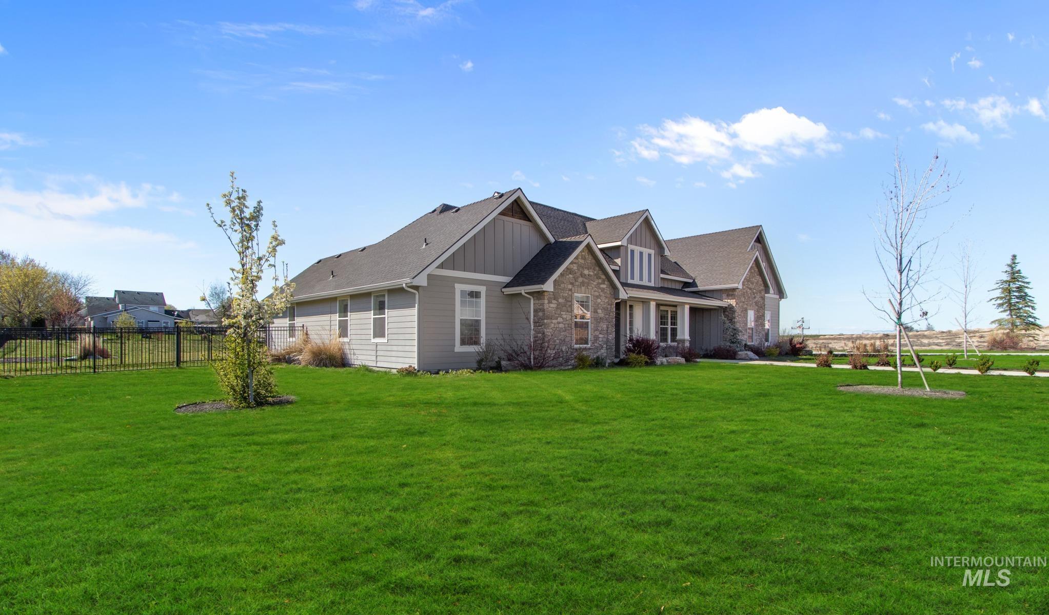 View of front of house featuring board and batten siding and stone siding