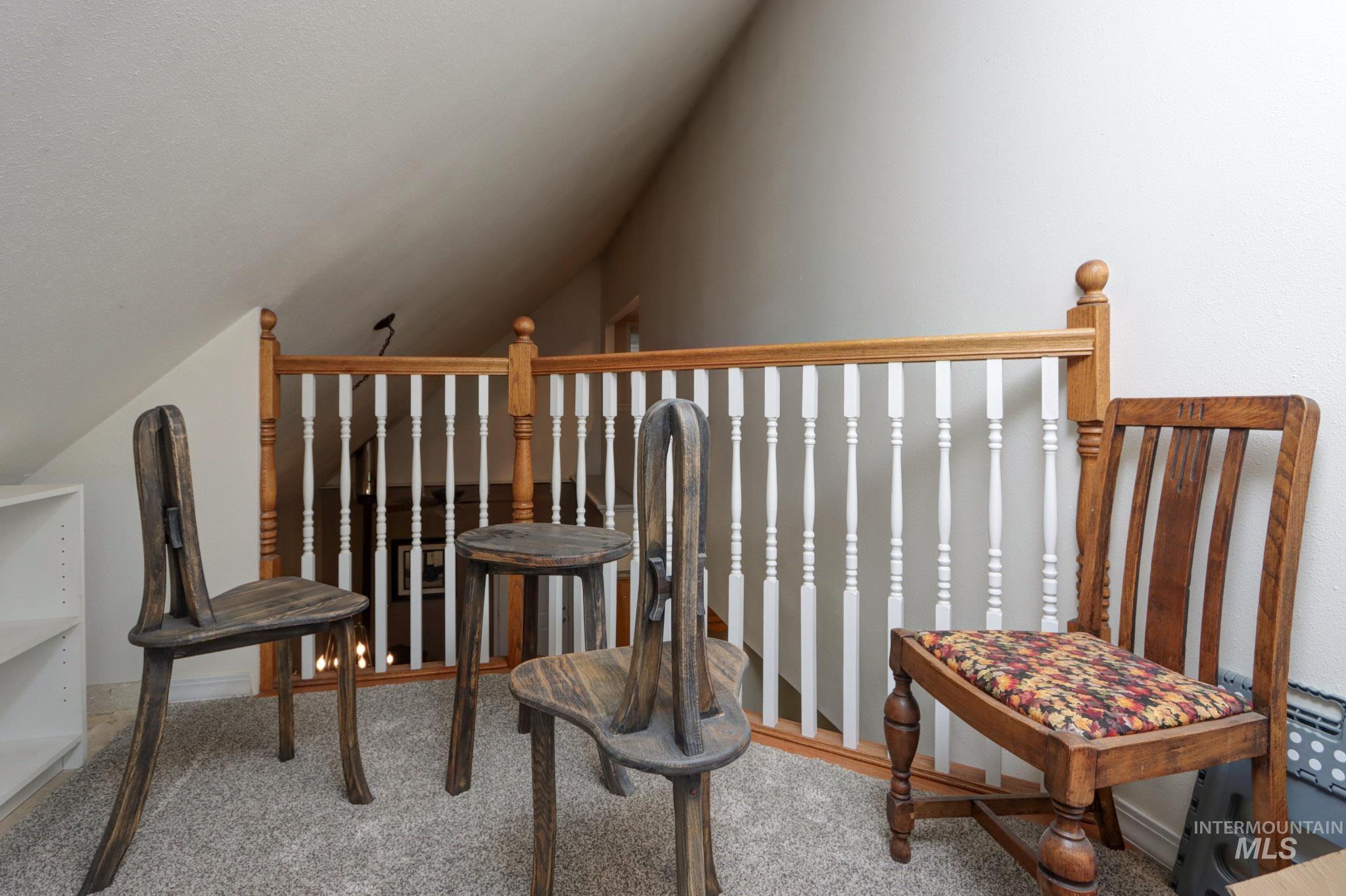 Living area featuring lofted ceiling and carpet