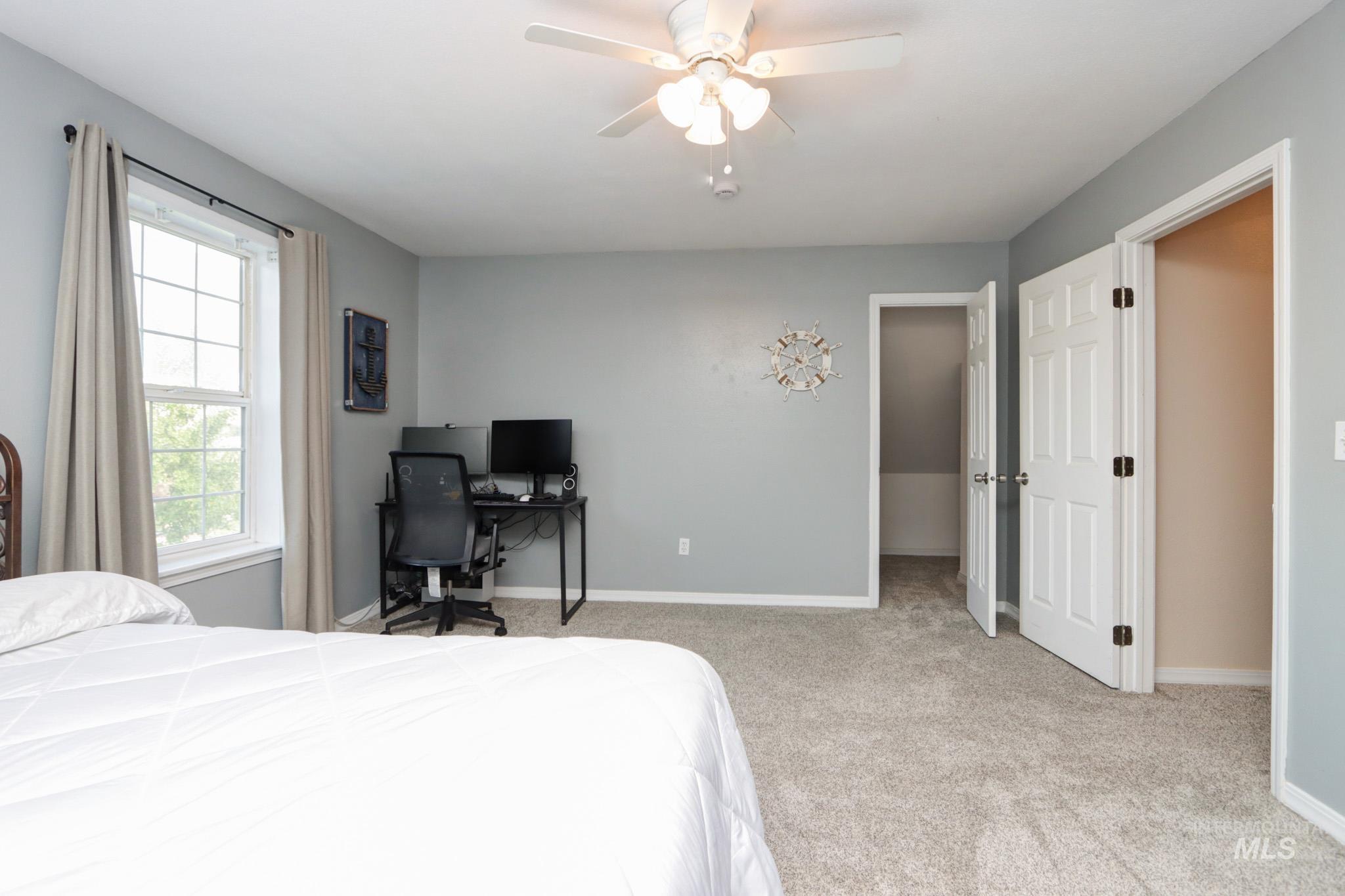 Bedroom with light carpet and ceiling fan